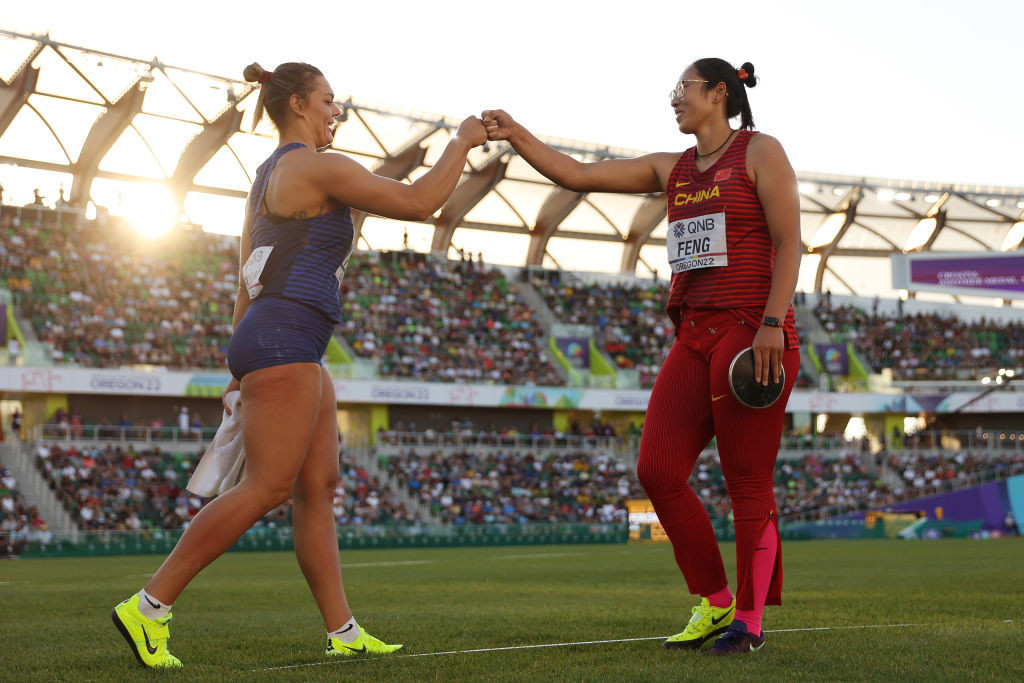 China's Bin Feng, surprise winner of the women's world discus title in Eugene, is congratulated by Croatia's silver medallist Sandra Perkovic ©Getty Images