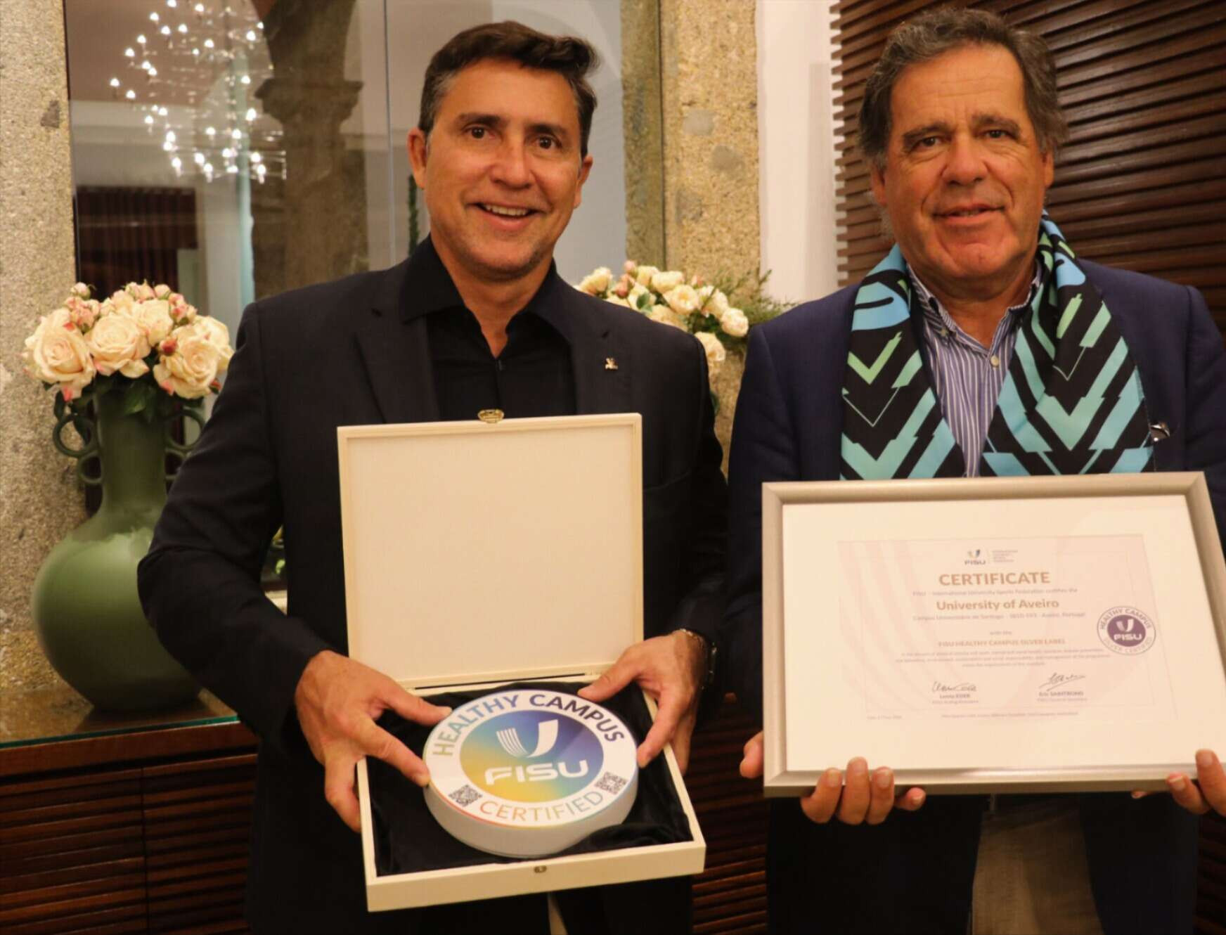 FISU's acting first vice-president Luciano Cabral, left, presented University of Aveiro vice-rector Manuel Matias with the certificate ©FISU