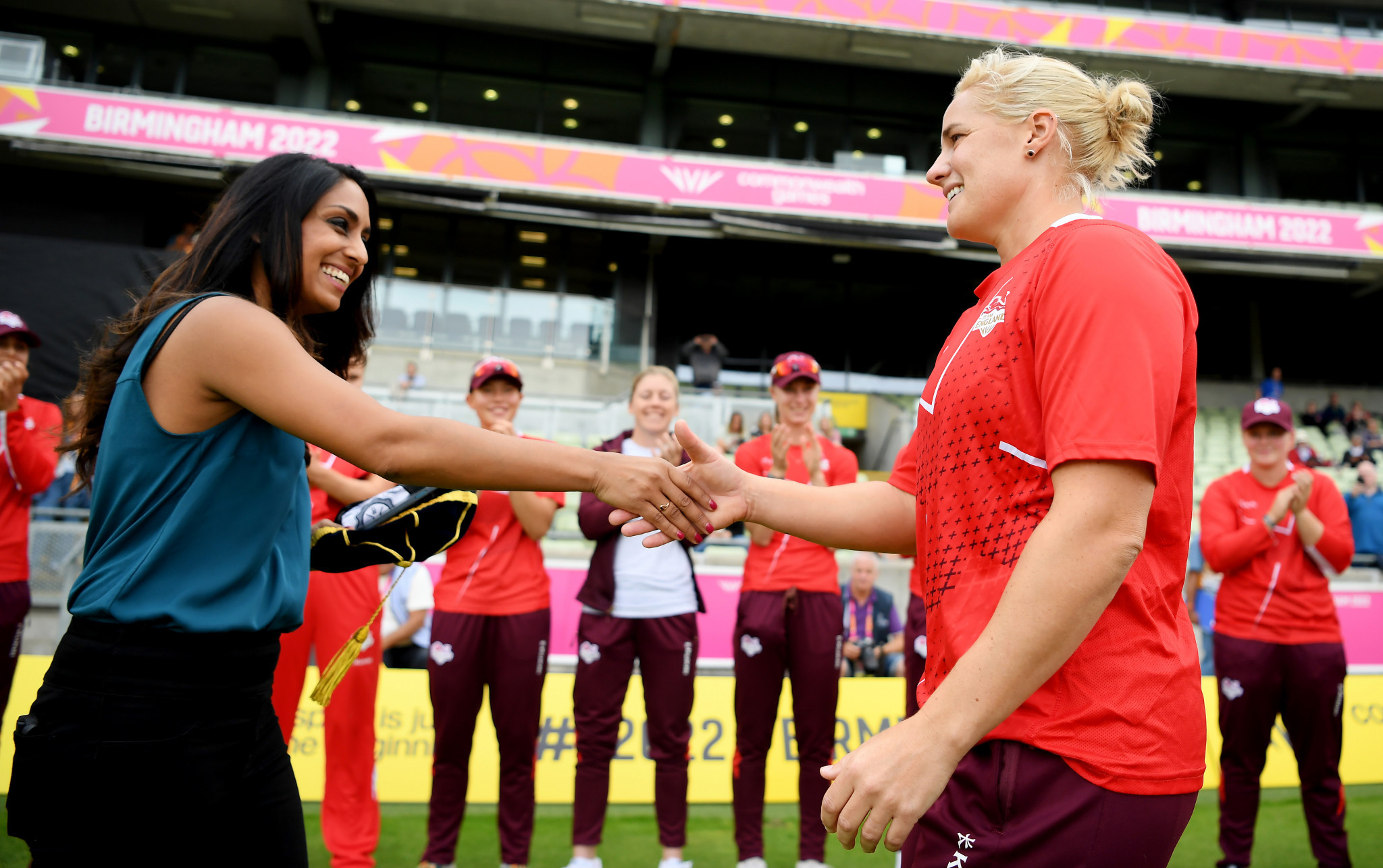 Former England player Isa Guha, left, presented Katherine Brunt with a special cap to mark her 100th T20 international ©Getty Images