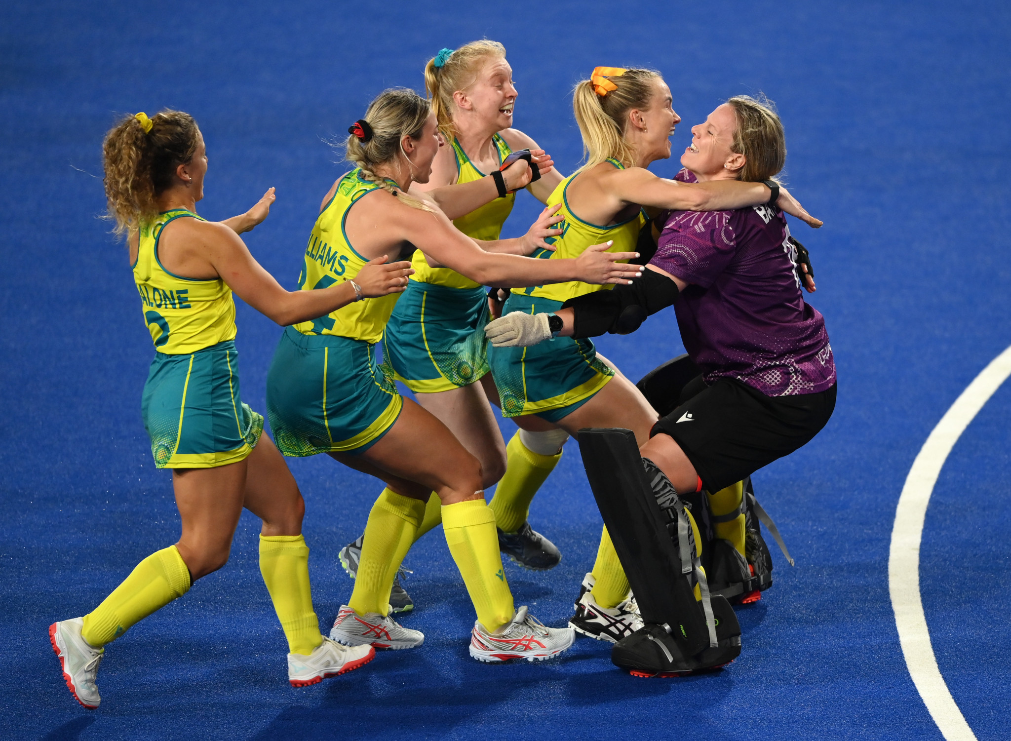Australia's hockey players rush to their goalkeeper Aleisha Power after the shoot out victory over India ©Getty Images