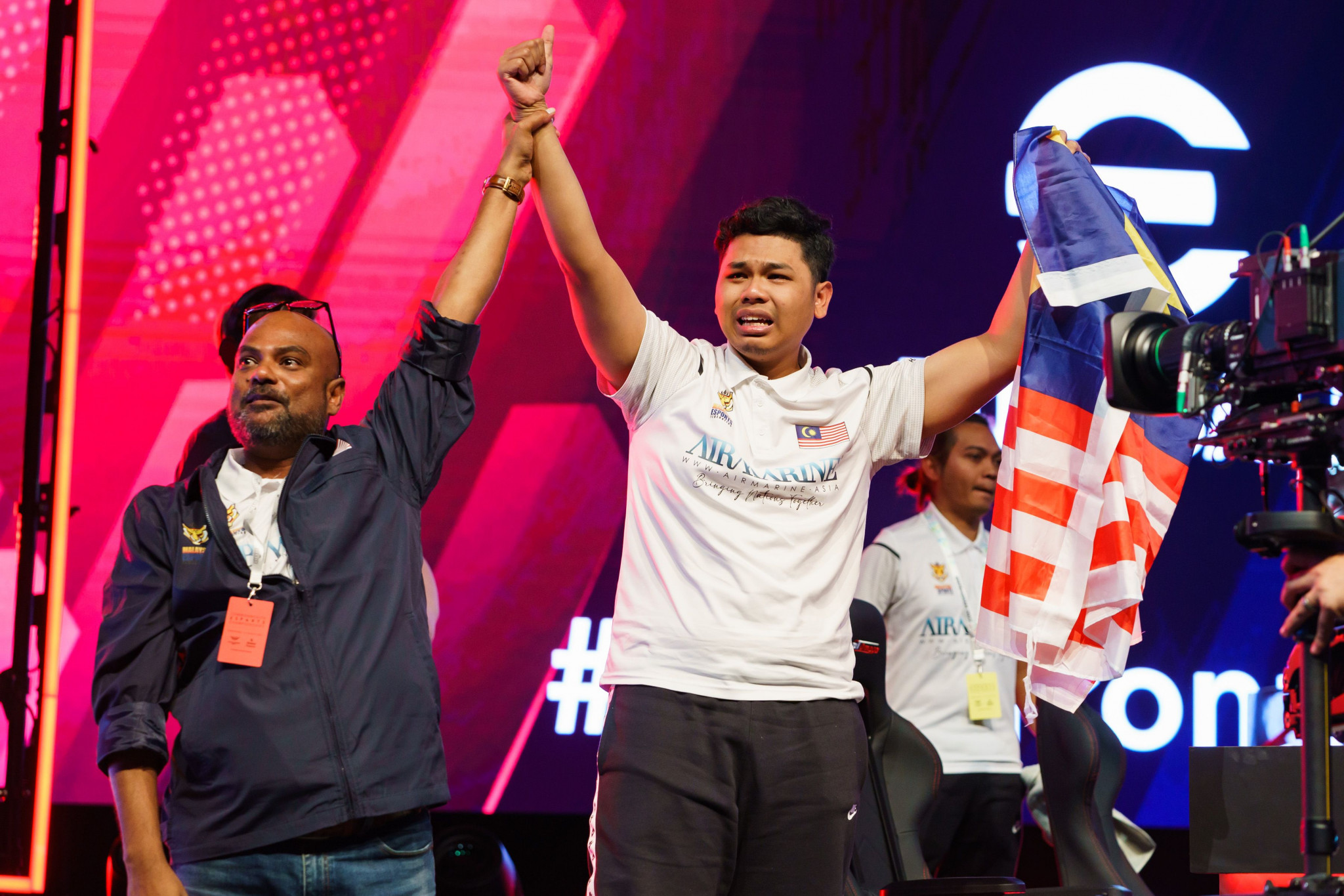 Haikal, right, was emotional after he won gold for Malaysia in the eFootball open ©GEF