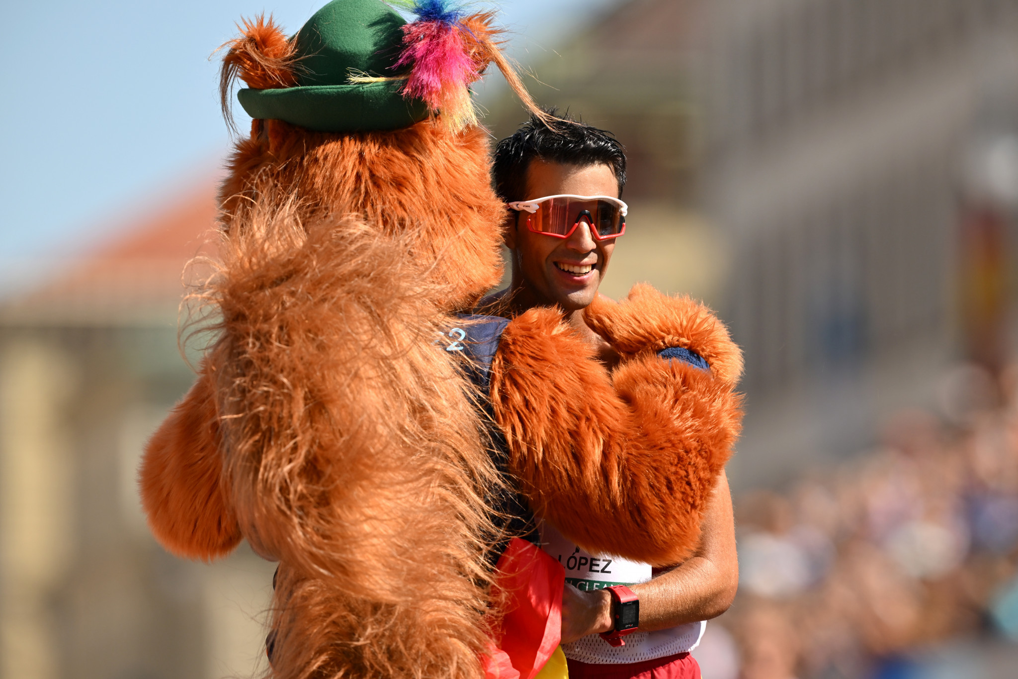 Miguel Angel Lopez celebrates his 35km race walk victory with the event's mascot ©Getty Images