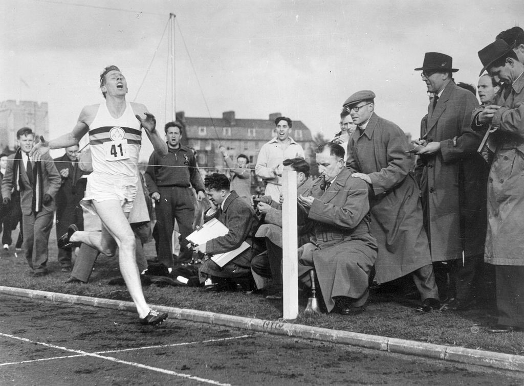The man - and the tape. Sir Roger Bannister approaches official confirmation that he has become the first man to beat four minutes for the mile at Oxford's Iffley Road stadium on May 6, 1954 ©Getty Images