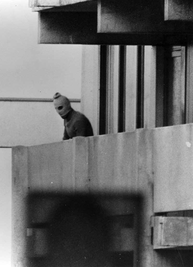 One of the eight Black September terrorists pictured on the balcony of an apartment housing Israeli athletes at the Munich 1972 Olympics ©Getty Images