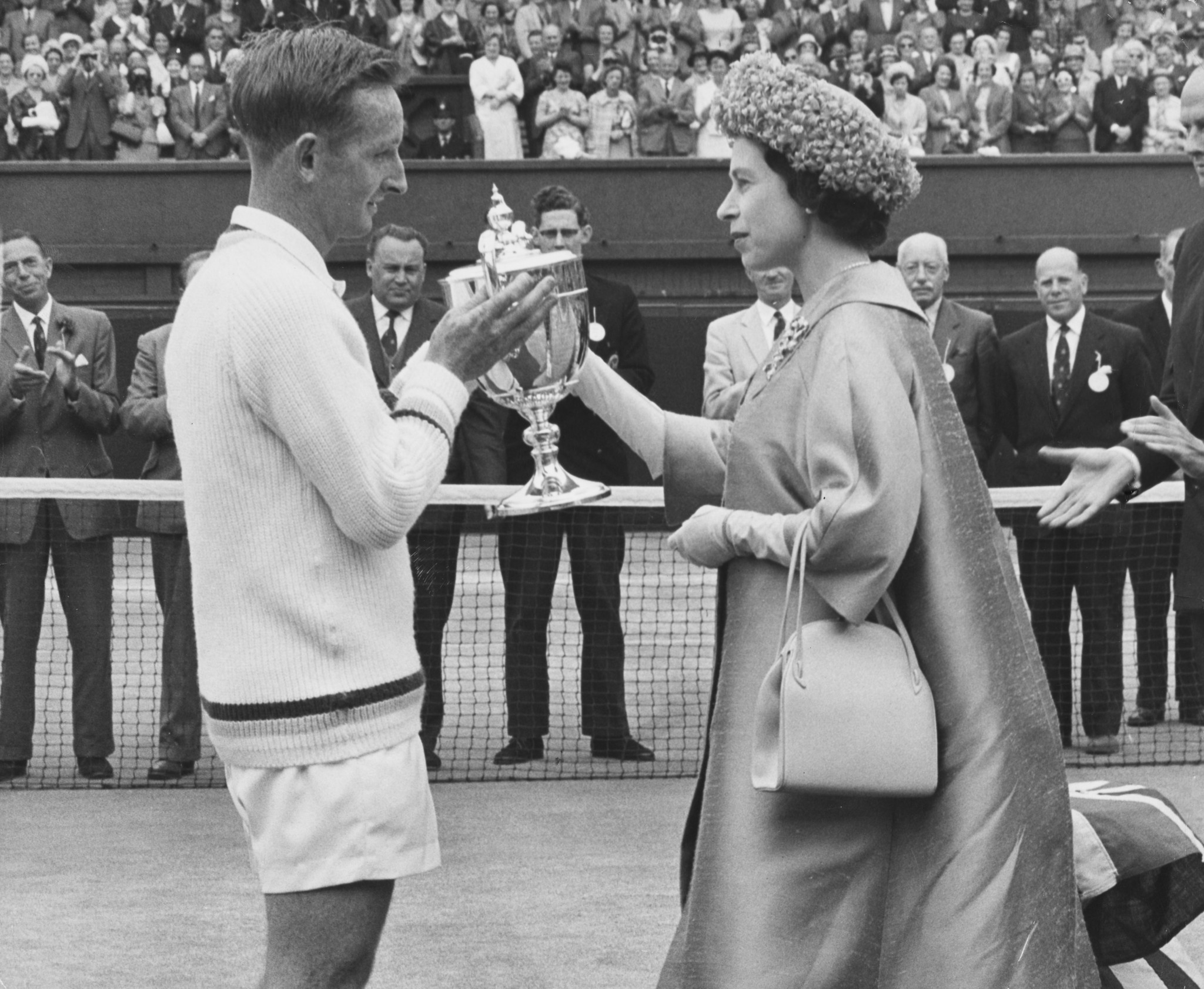 Rod Laver, left, received the Wimbledon men's singles trophy from Queen Elizabeth II in 1962 before completing his first calendar Grand Slam ©Getty Images