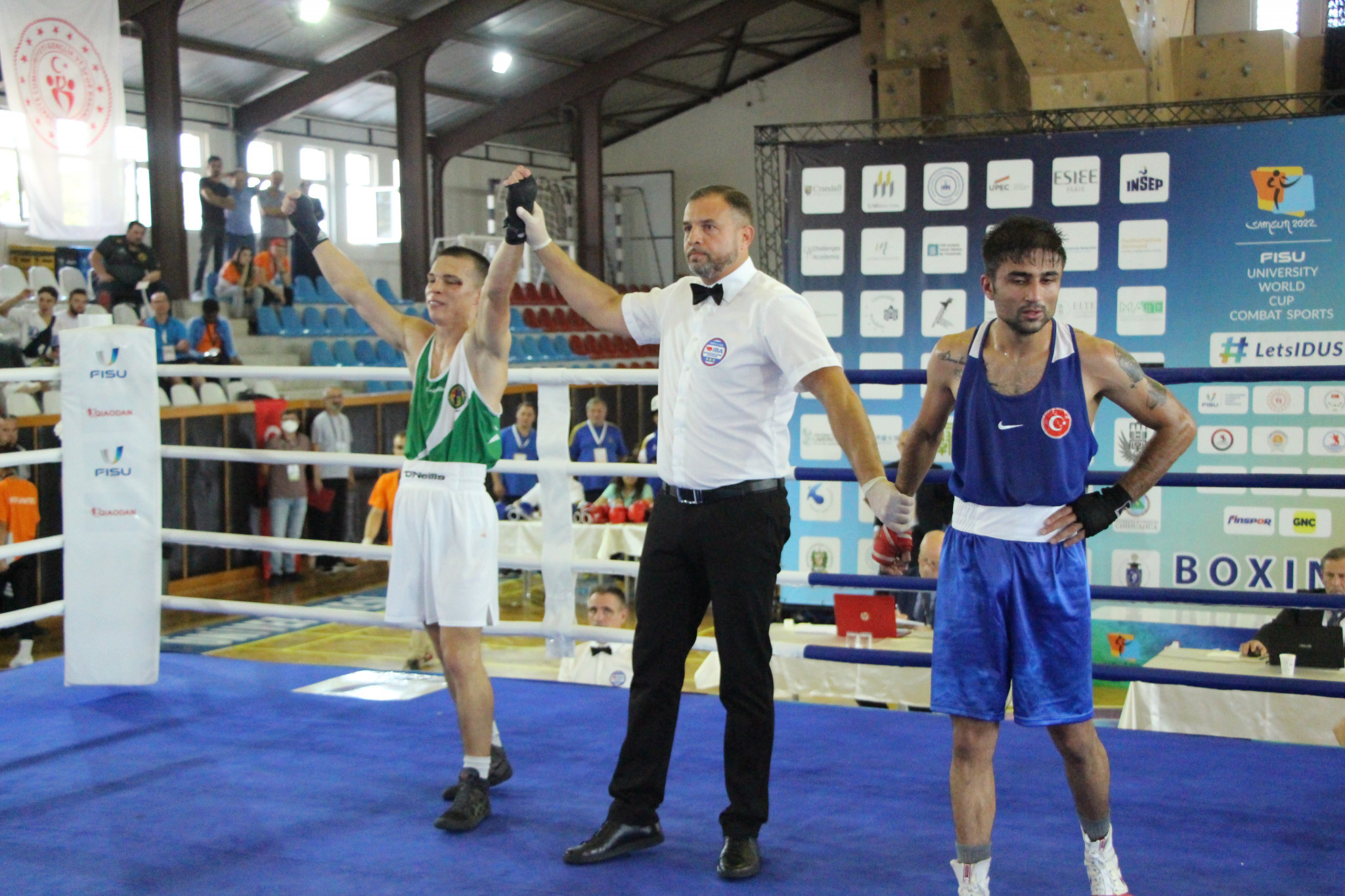 Ireland's Patryk Adamus, left, got the gold medal in his under-75kg boxing bout ©FISU