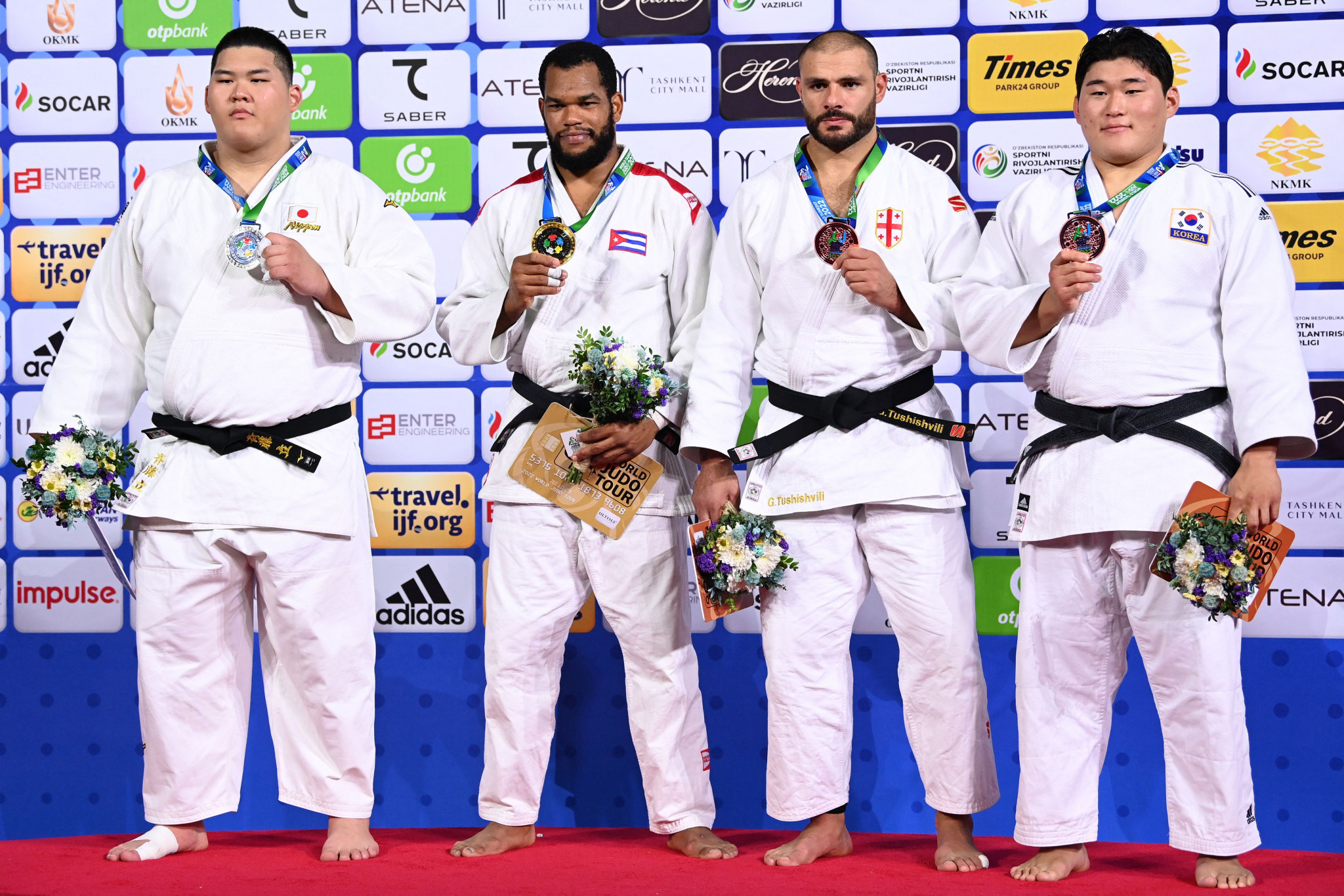 Georgia's Guram Tushishvili, third right, and South Korean Kim Min-jong, right, made up the rest of the podium after winning the bronze-medal matches ©Getty Images