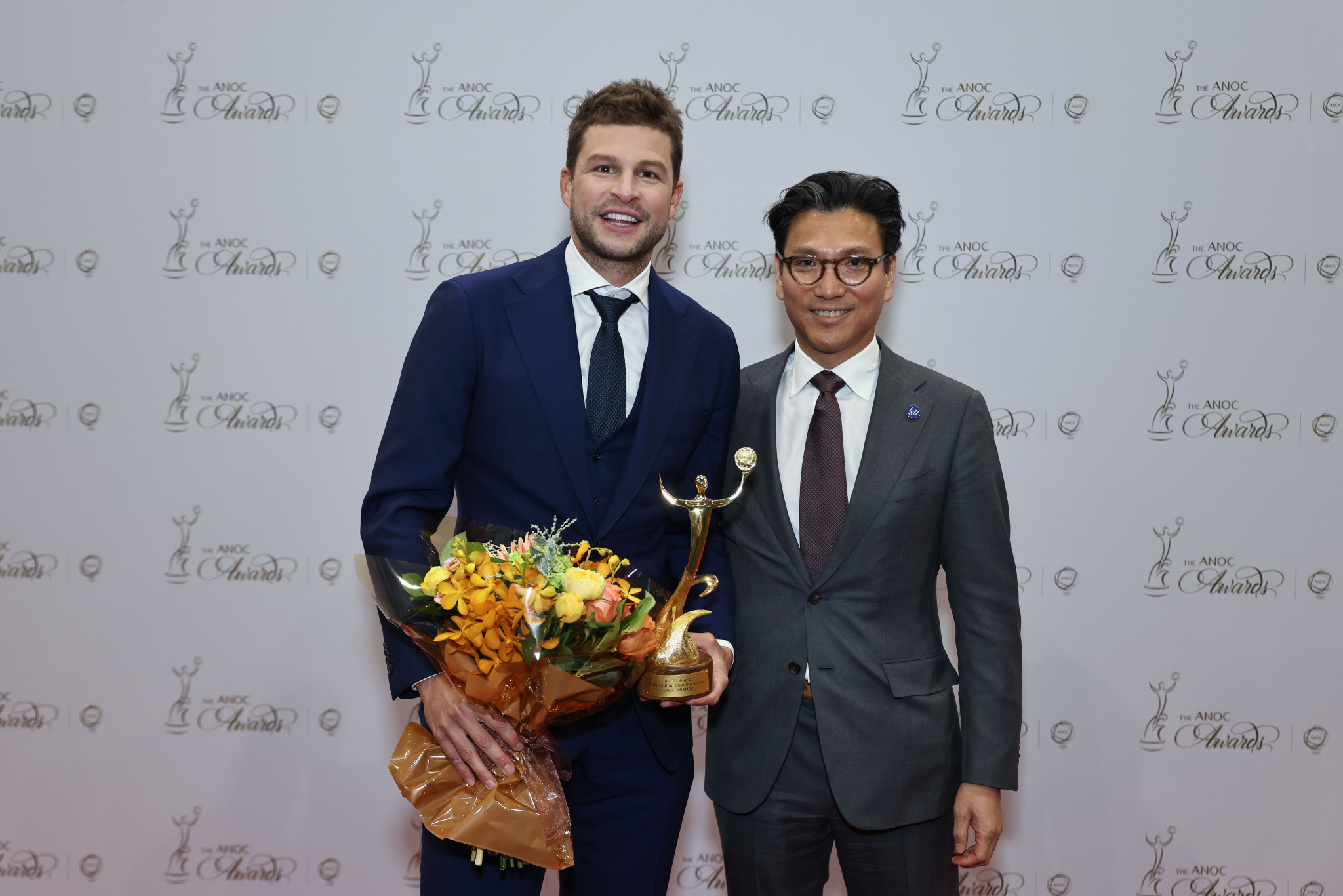 Dutch four-time speed skating champion Sven Kramer stands next to International Skating Union President Kim Jae-youl  after winning the outstanding athlete performance award ©ANOC