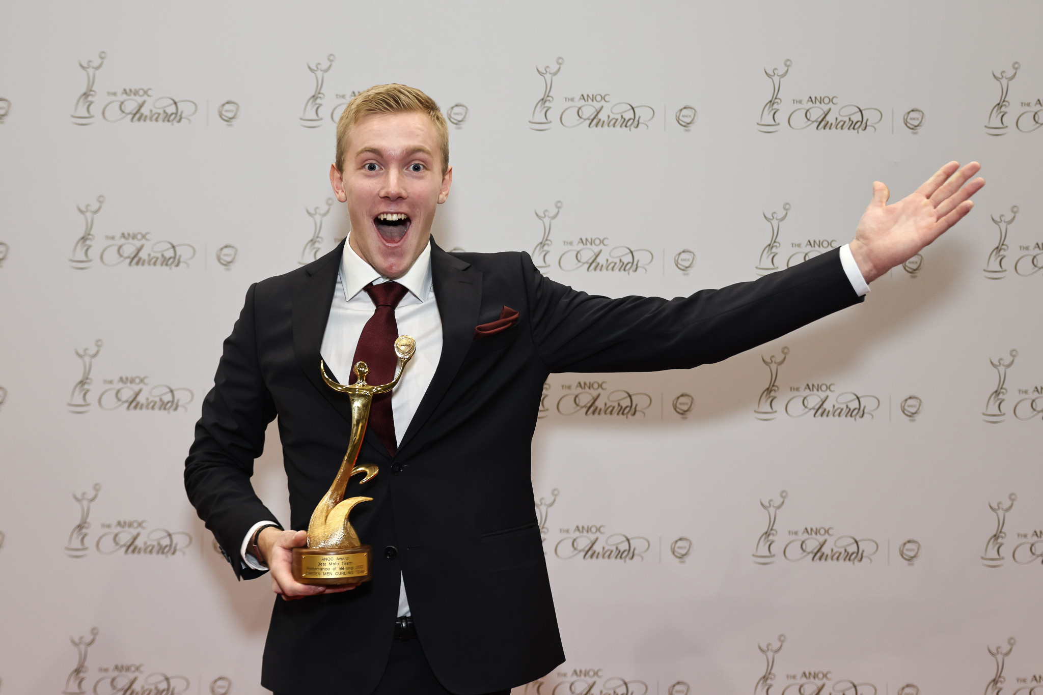 Daniel Wilhelm Magnusson celebrates after picking up the best men's team award on behalf of the Swedish men's curling team who won gold in Beijing ©ANOC
