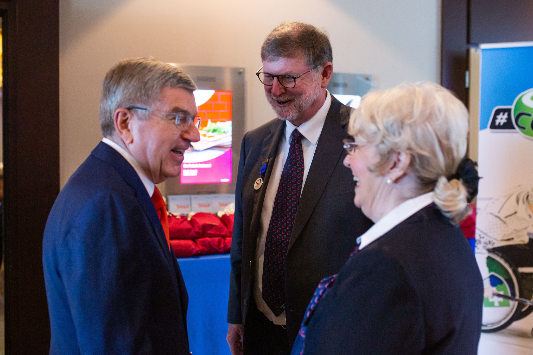 International Olympic Committee President Thomas Bach, left, pictured at the WCF Congress alongside Beau Welling and Kate Caithness, right ©WCF/Celine Stucki