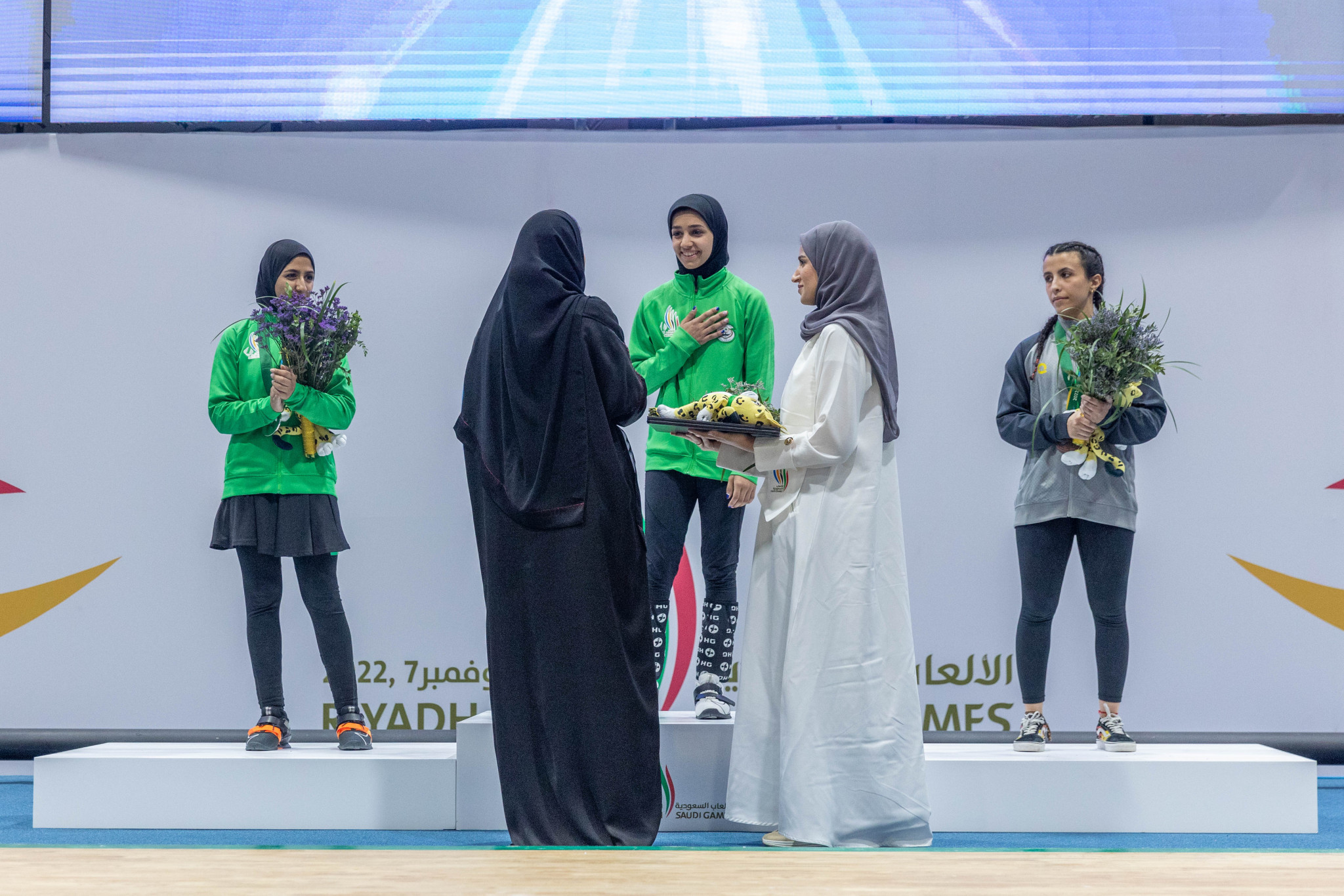 Rahmah Alkhawahr, centre, was honoured after she became the first gold medallist in Saudi Games history ©Saudi Games