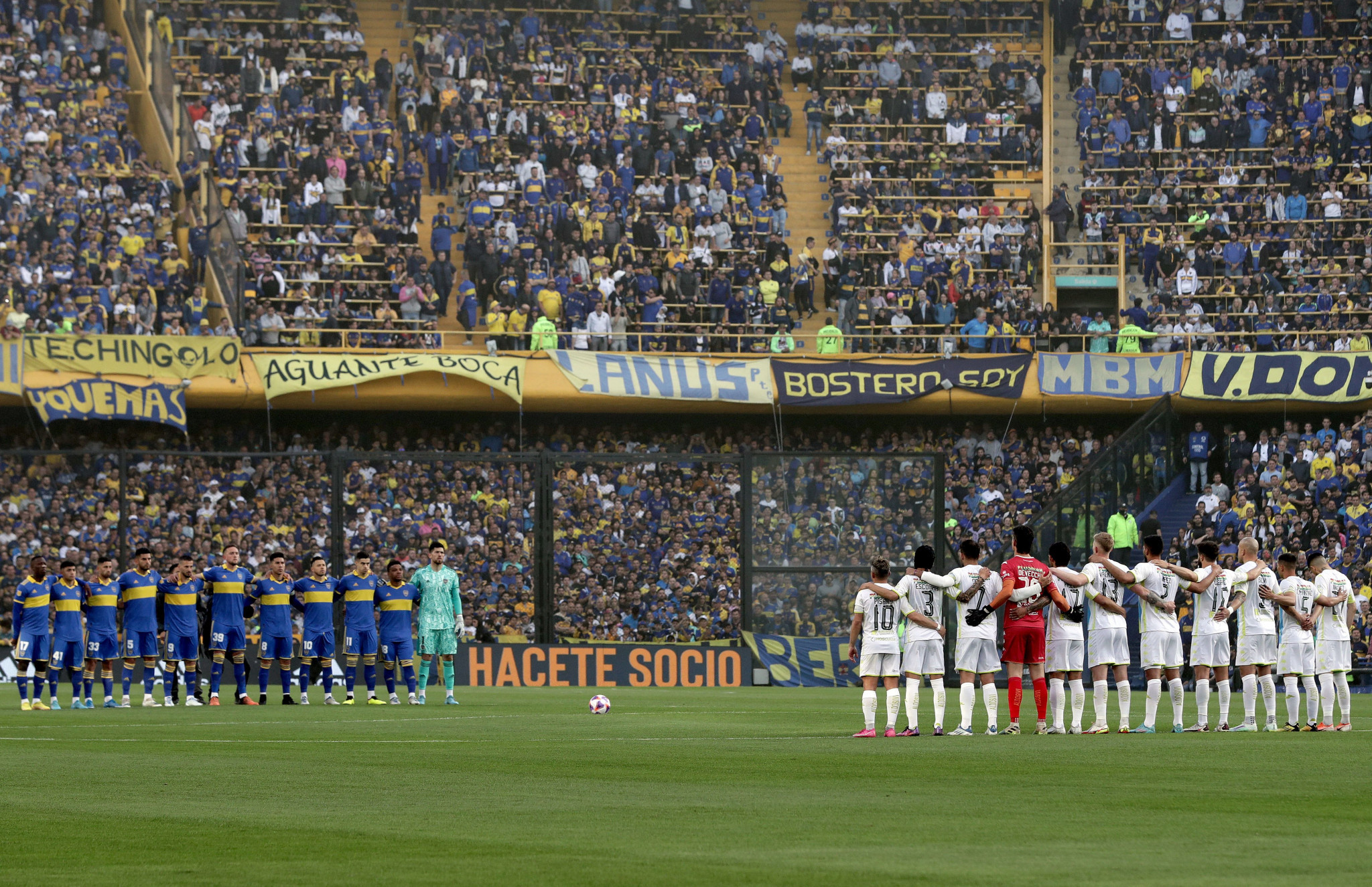 Players and fans stand in remembrance of a fan who died during crowd disturbances last month in Buenos Aires ©Getty Images