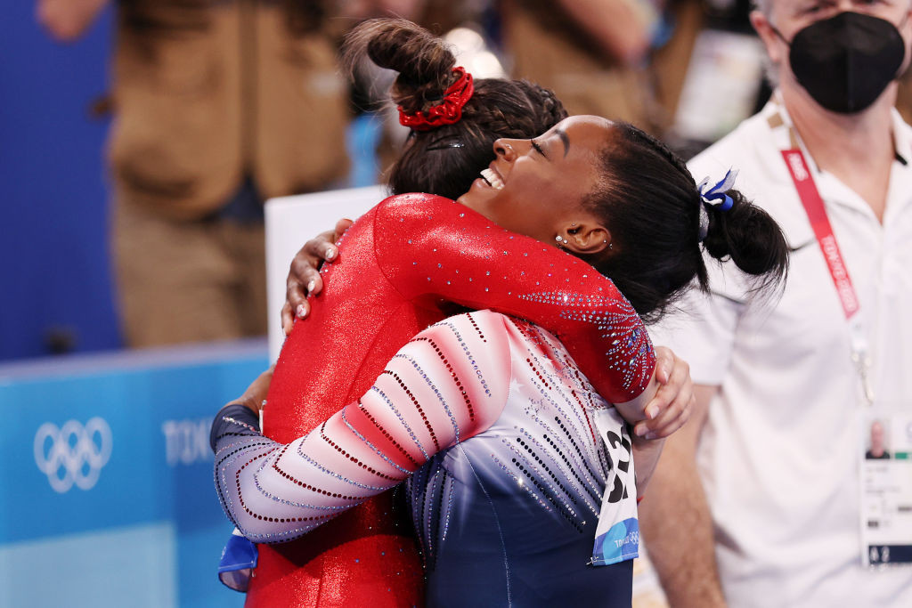 Sunisa Lee, pictured being embraced by the US team-mate whom she succeeded as Olympic all-around gymnastics champion, Simone Biles, will quit college next year to focus on her Paris 2024 defence ©Getty Images