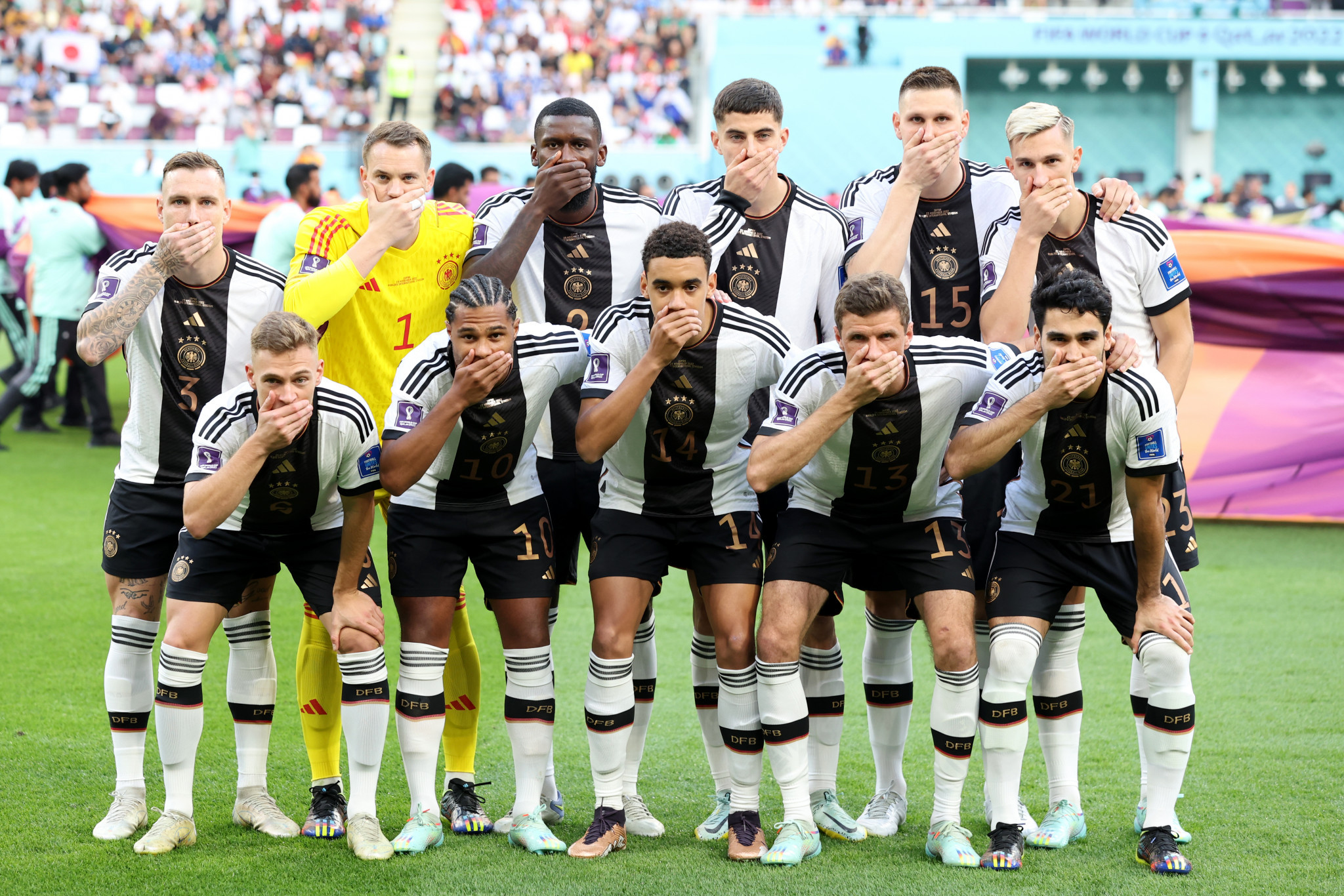 German footballers covered their mouths during the team photo to protest against FIFA's threat to sanction players for wearing the 