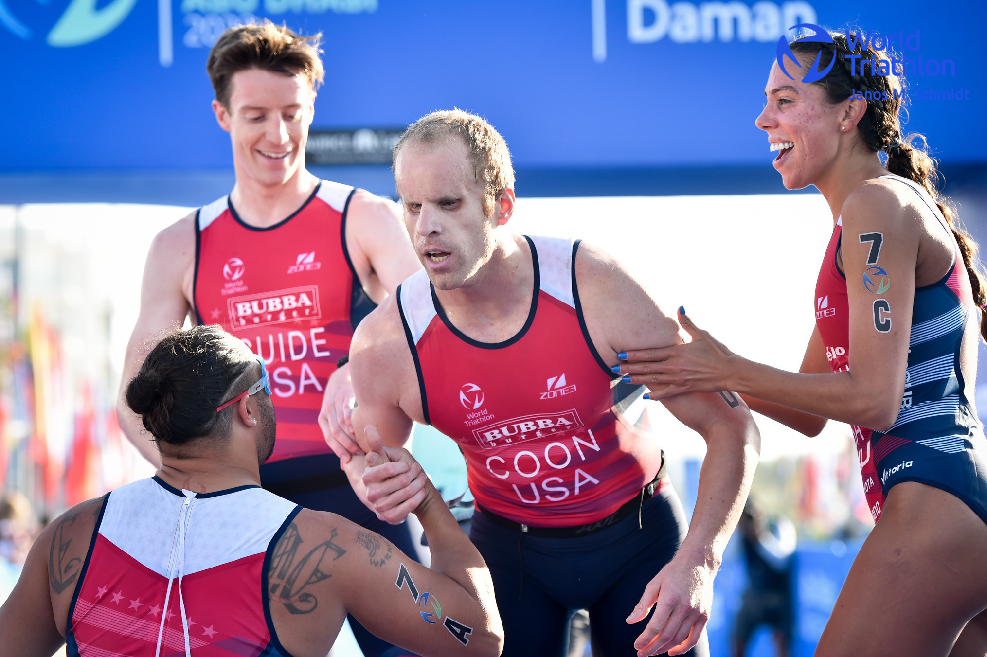 Kyle Coon, second right, raced the final leg to secure bronze for the other American team competing in the relay ©World Triathlon