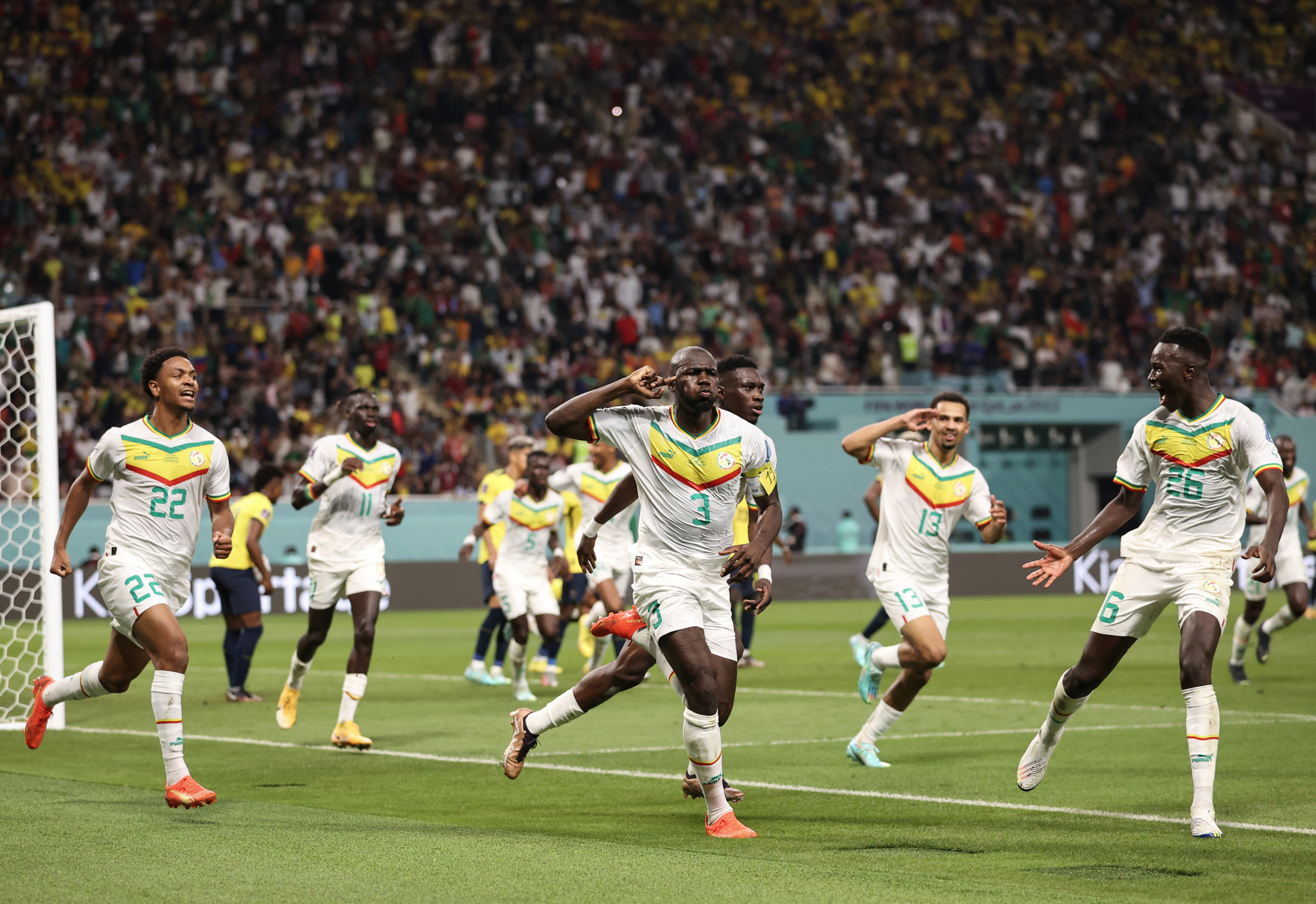 Senegal's players celebrate after scoring the crucial goal to beat Ecuador and reach the last 16 ©Getty Images
