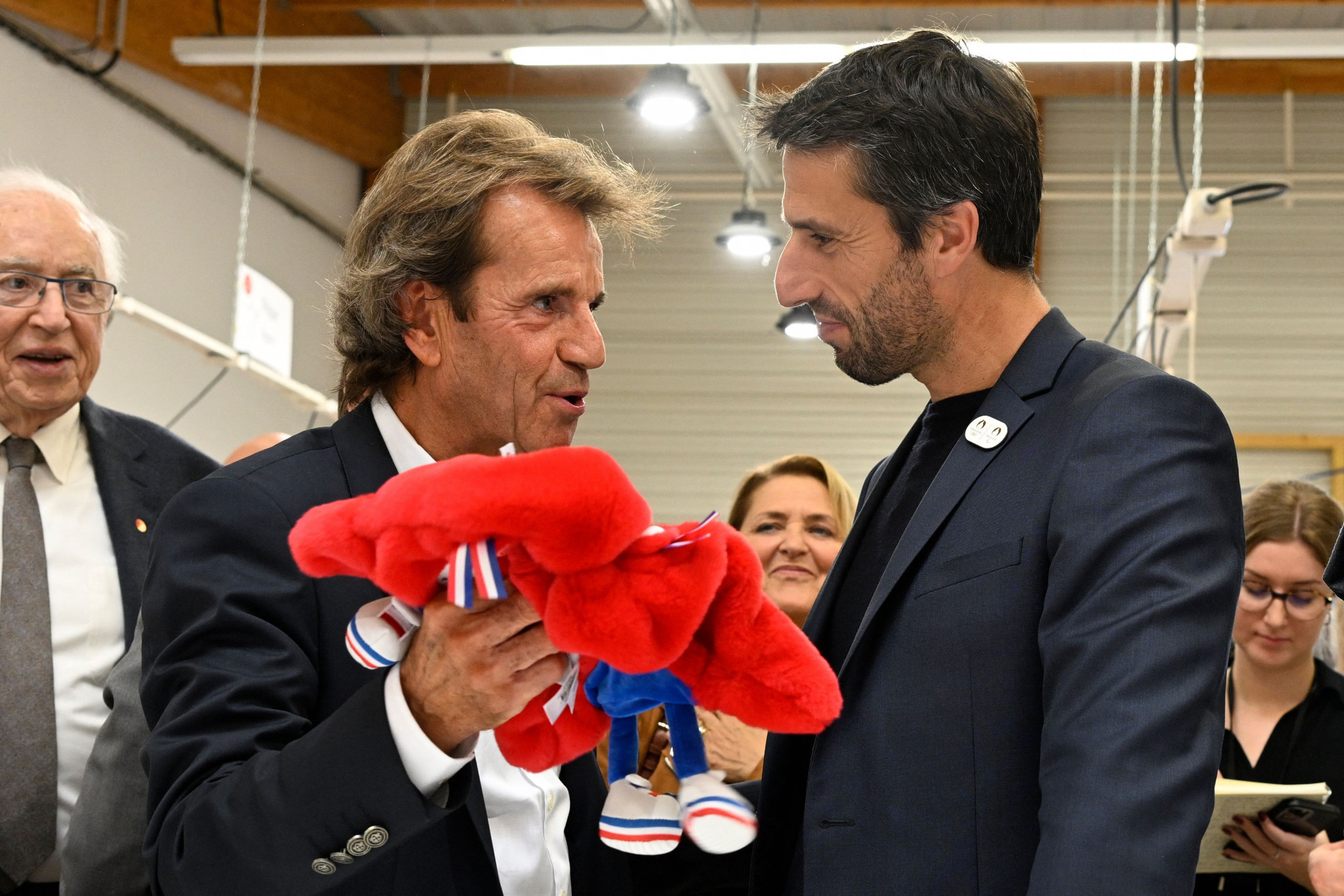 Doudou et Compagnie President Alain Joly, left, shows a mascot to Paris 2024 President Tony Estanguet as production began at a French factory this week ©Getty Images