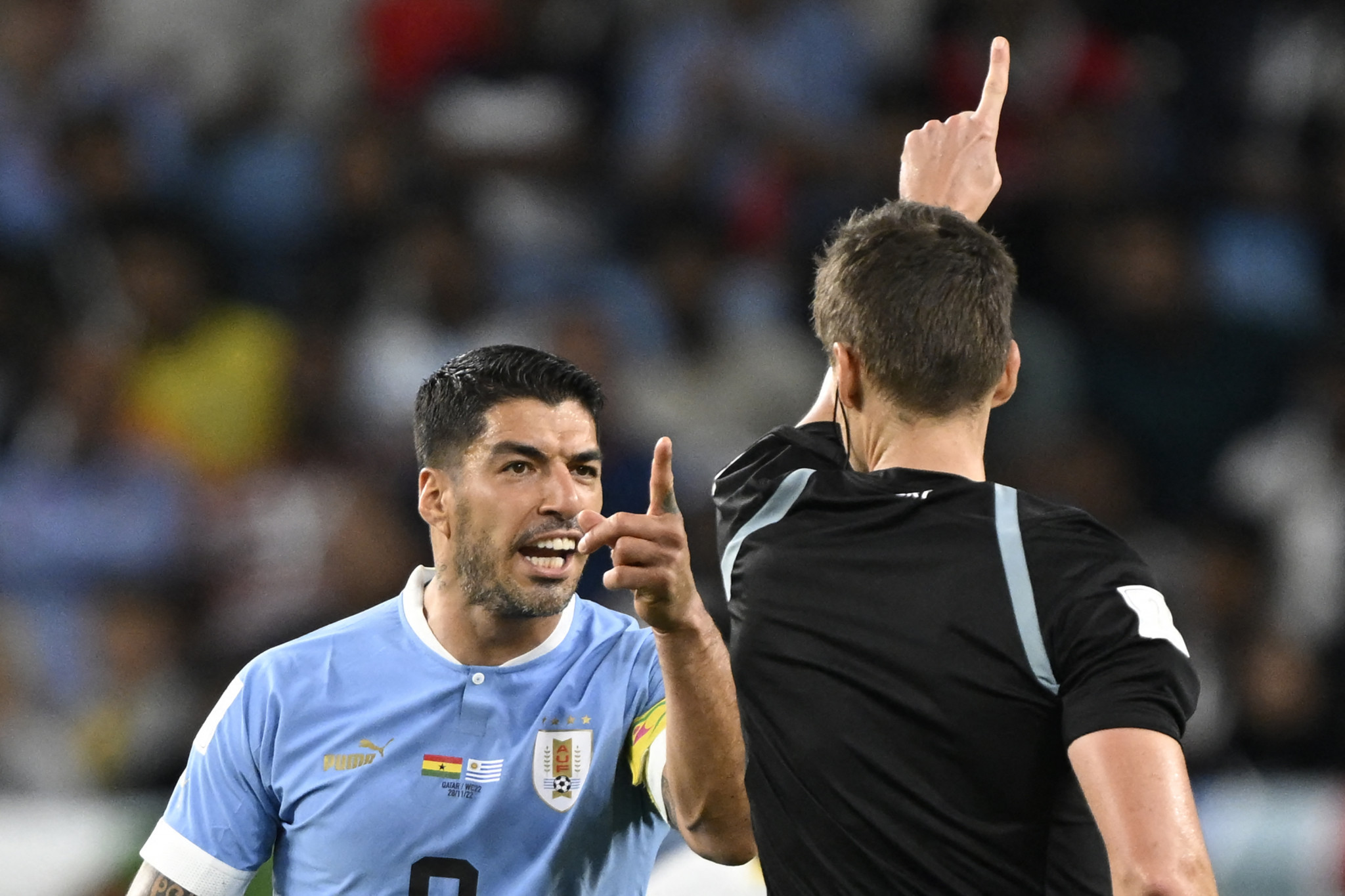 Ghanaian enemy and Uruguayan striker Luis Suarez arguing with the referee ©Getty Images