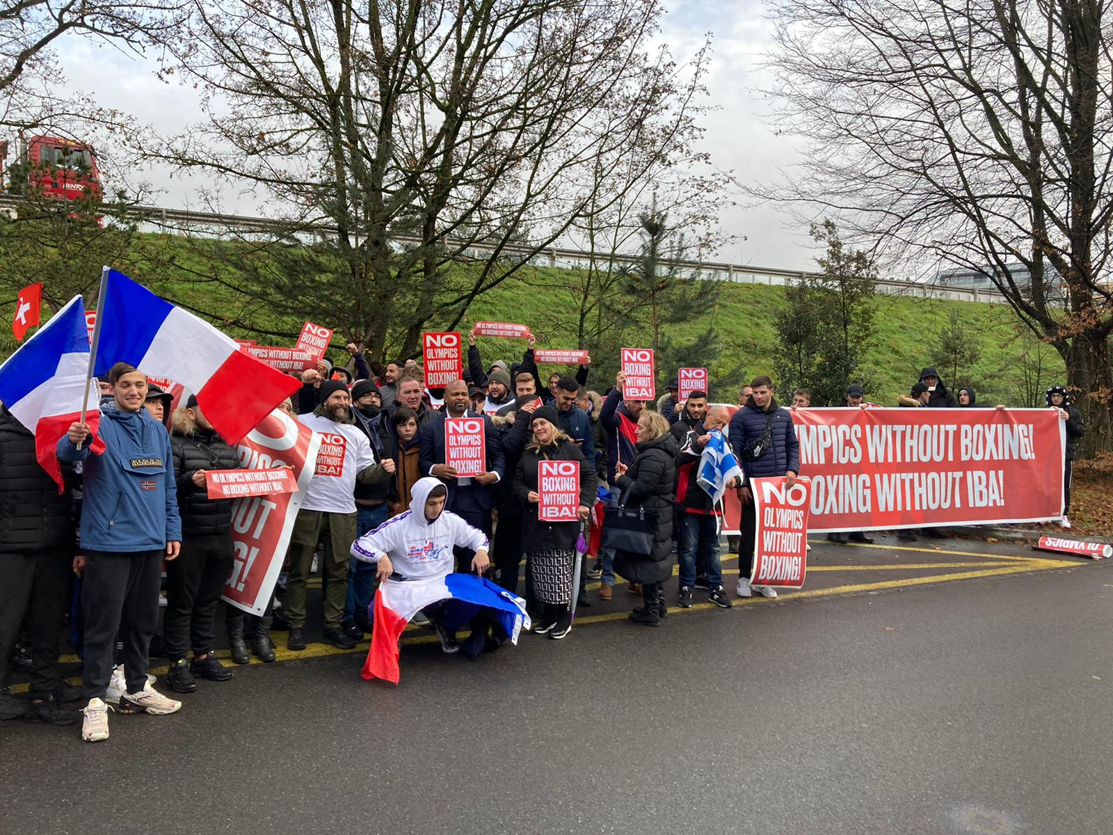 A group protesting about the decision to exclude boxing from the Olympic programme at Los Angeles 2028 gathered outside Olympic House in Lausanne ©ITG