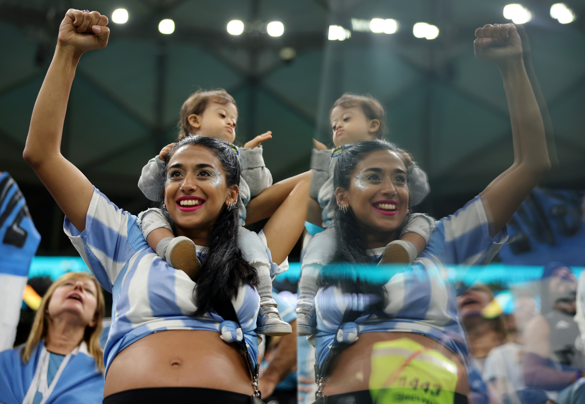 An Argentina fan raises an arm in celebration following her side's comfortable win ©Getty Images