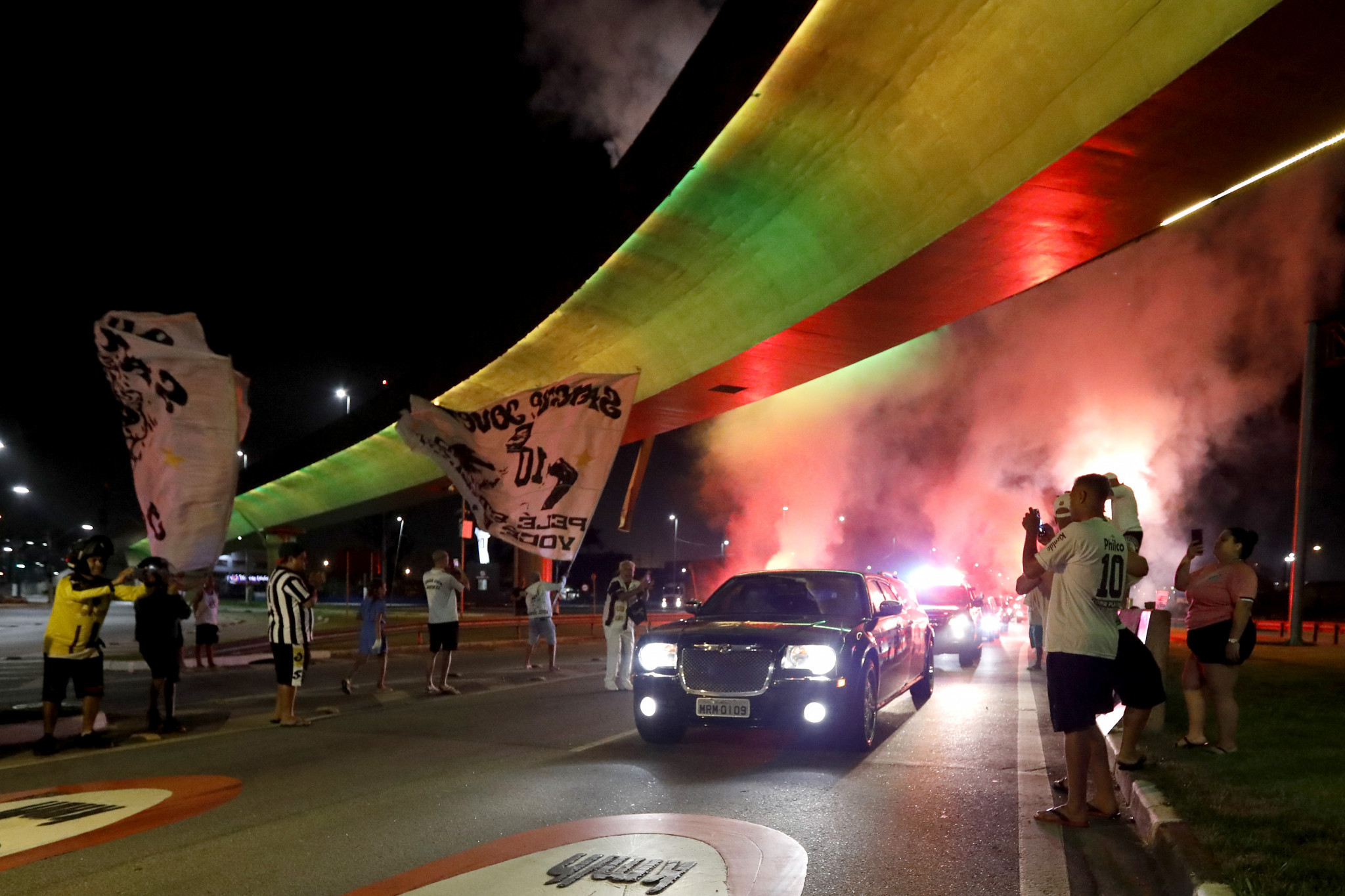 Fans brought fireworks to greet Pelé's coffin as it was transferred from a hospital in São Paulo to Santos FC's Estádio Urbano Caldeira ©Getty Images