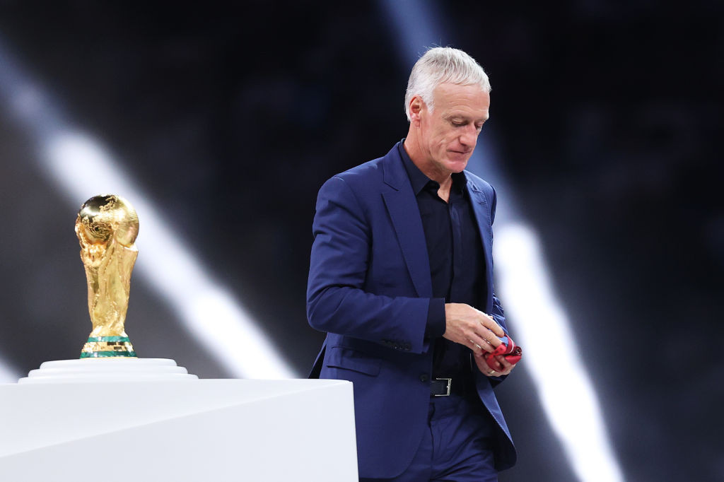 Didier Deschamps, pictured passing the FIFA World Cup trophy which France narrowly failed to defend successfully in Qatar, has signed a new deal as head coach until 2026 ©Getty Images
