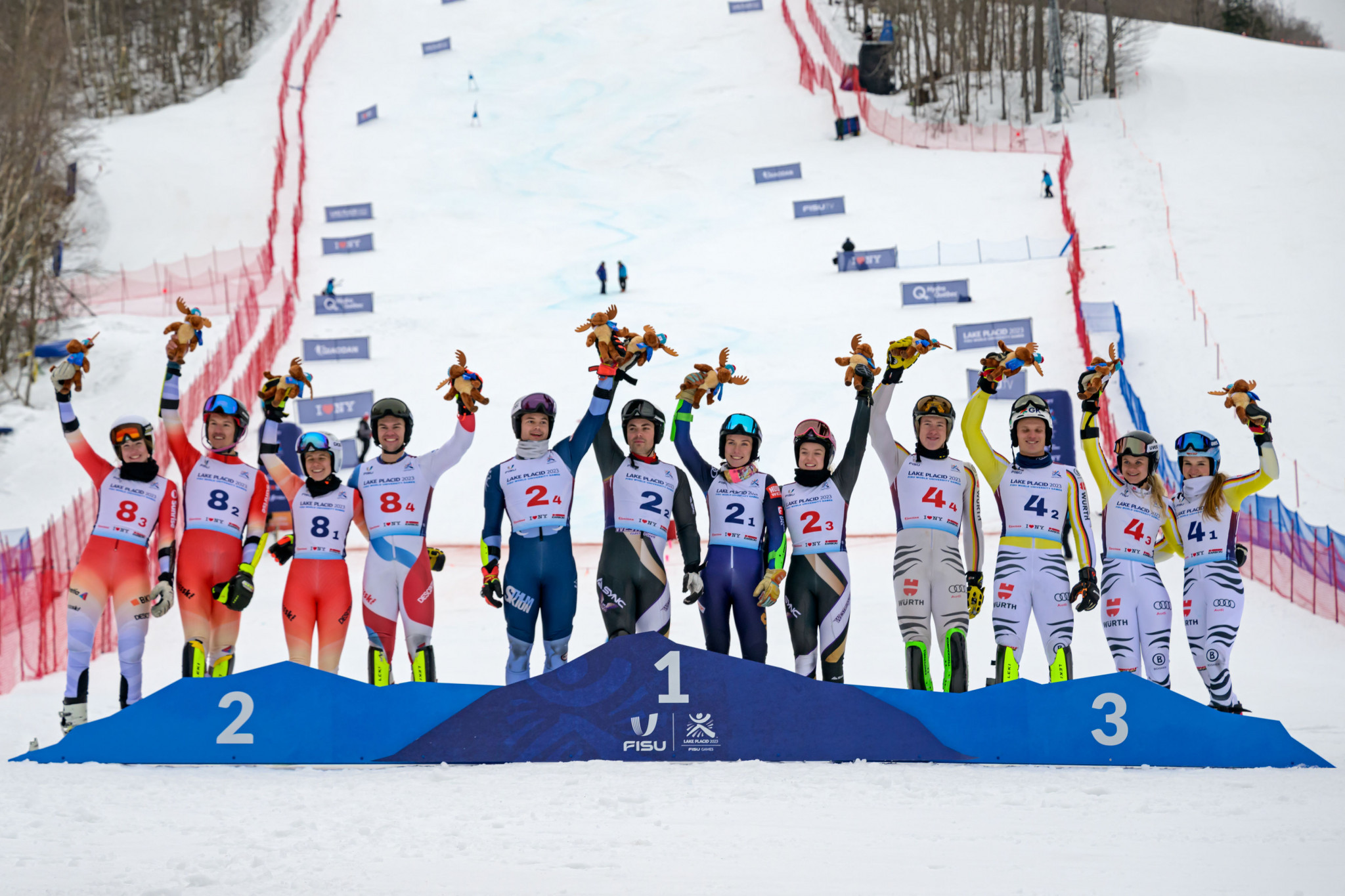 Sweden, centre, celebrate winning the mixed team parallel final at Whiteface Mountain ©FISU