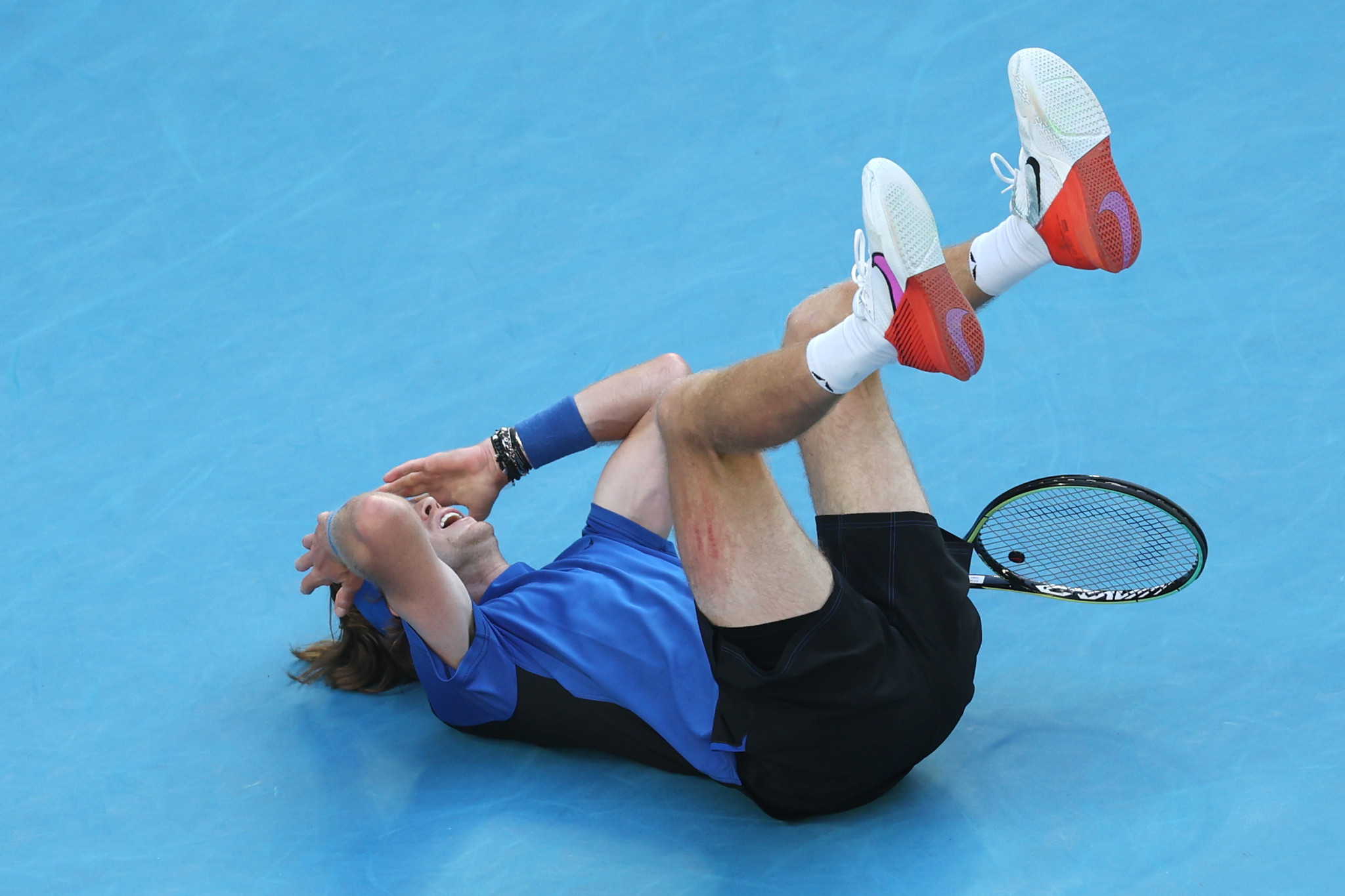 Andrey Rublev collapsed to the ground after triumphing in a fifth set tie-break as he won an epic contest with Holger Rune ©Getty Images