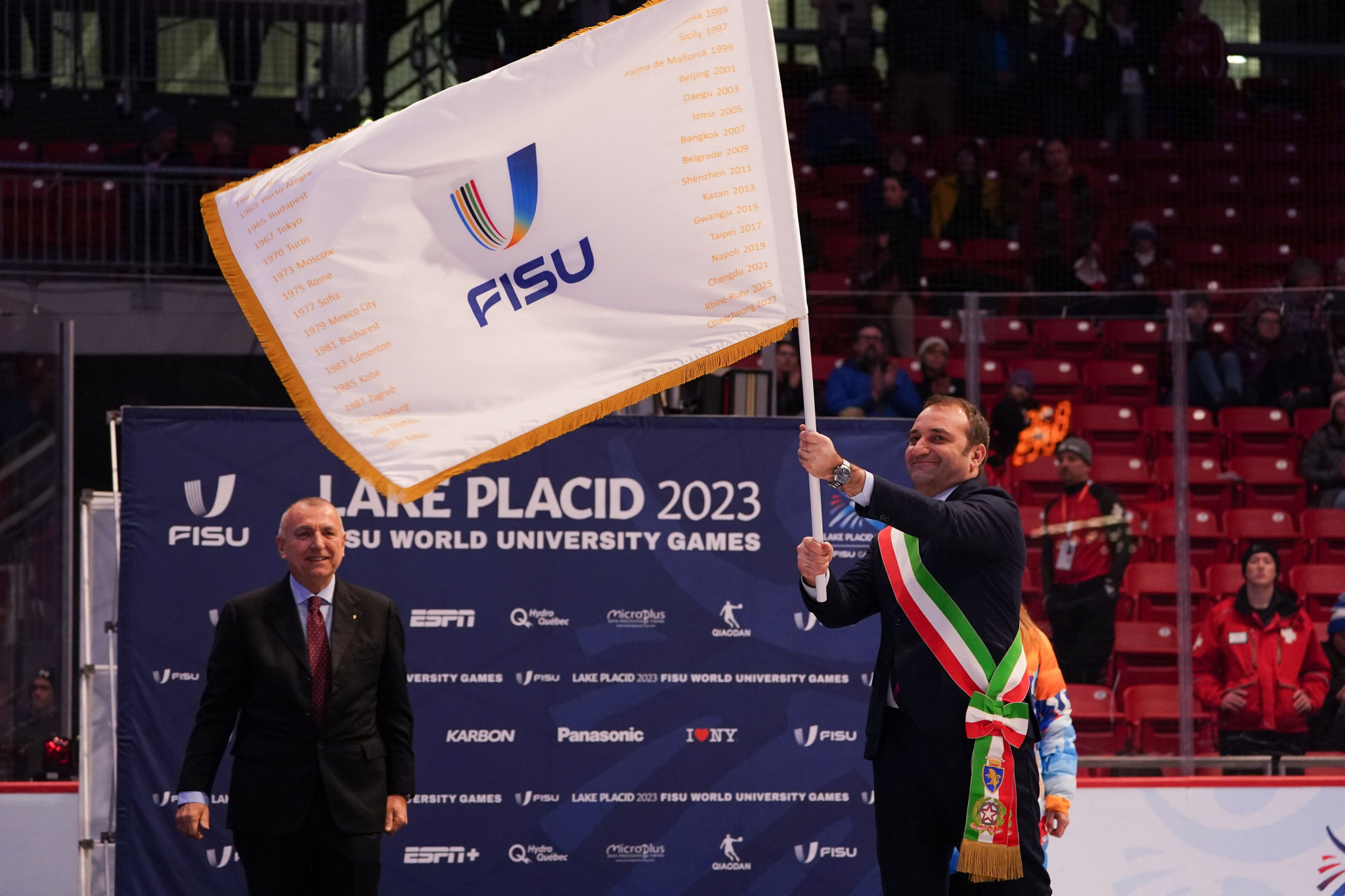 Turin Mayor Stefano Lo Russo receives the FISU flag during the Handover Ceremony at Lake Placid 2023 ©FISU