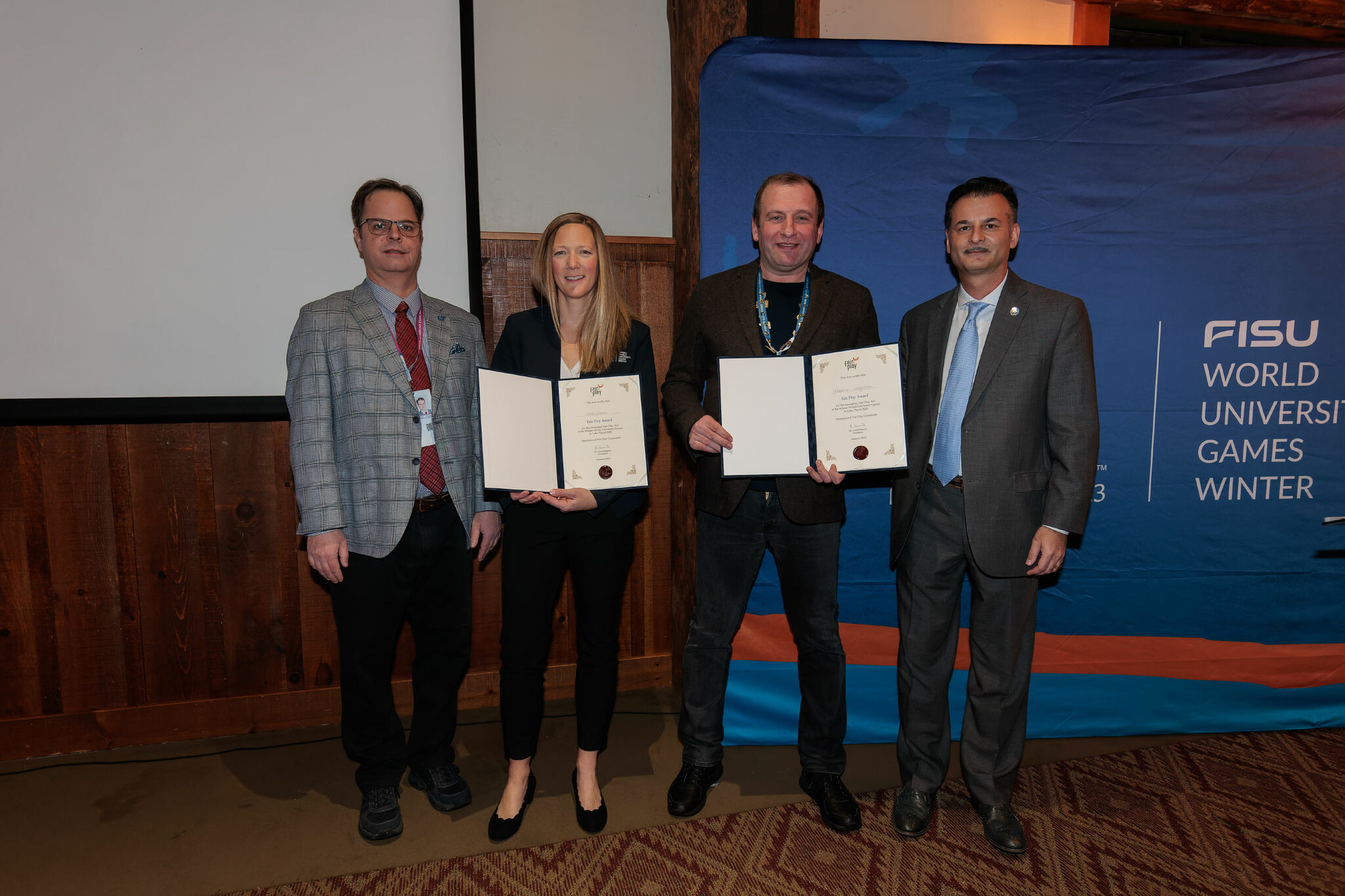 Lake Placid 2023 executive director Ashley Walden, second left, also received an award on behalf of all of the volunteers that helped to stage the Games ©FISU