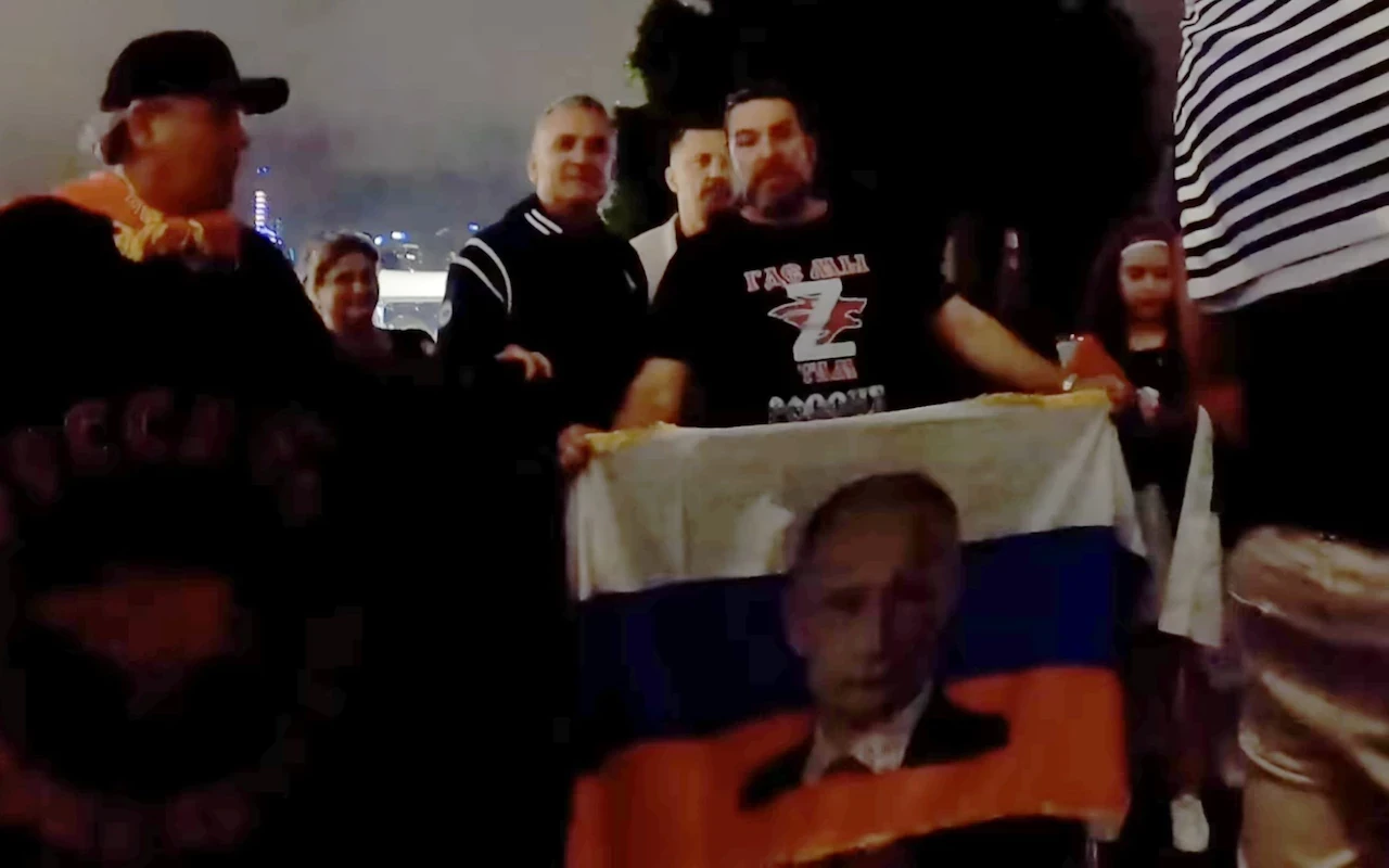 Novak Djokovic's father Srdjan, second left, poses with a man wearing a Z T-shirt and holding a Putin flag ©Twitter