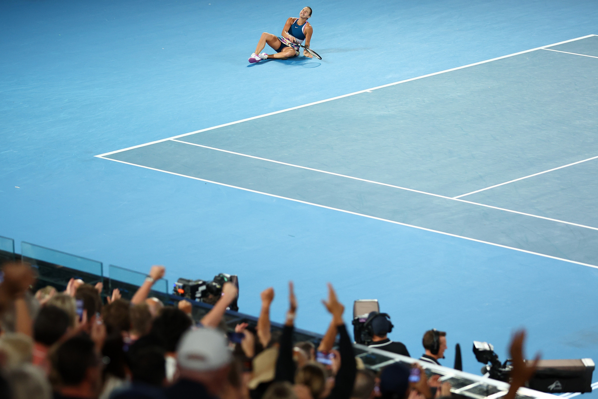 The crowd celebrates as Sabalenka collapses following her comeback triumph ©Getty Images