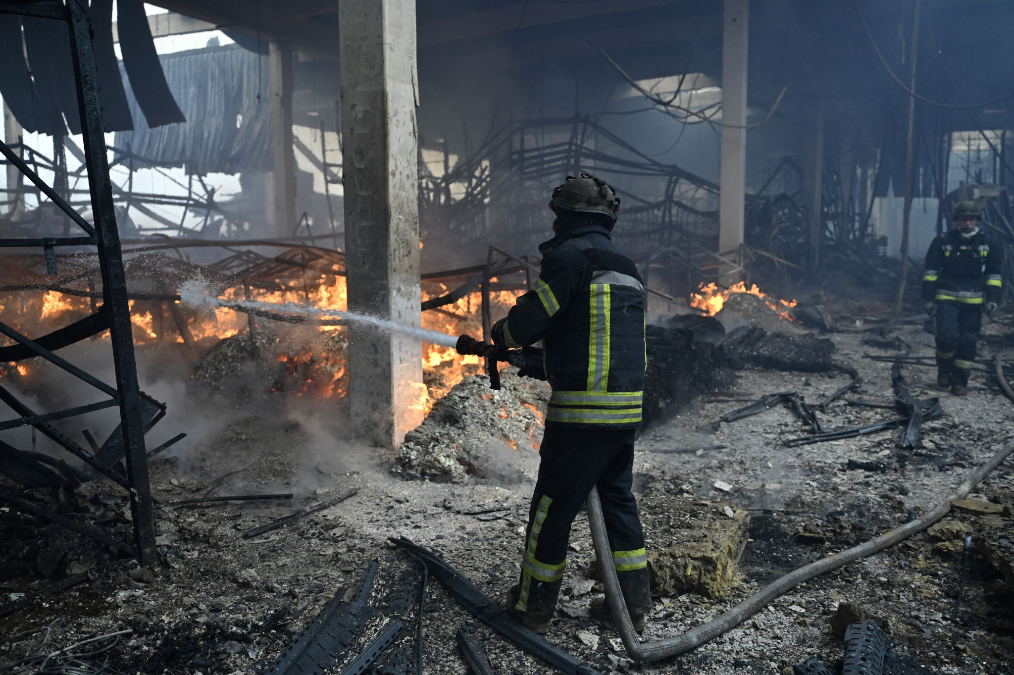 Ukrainian firefighters put out fire in a hardware shopping mall following shelling in Kherson as the country remains under attack from Russian forces ©Getty Images