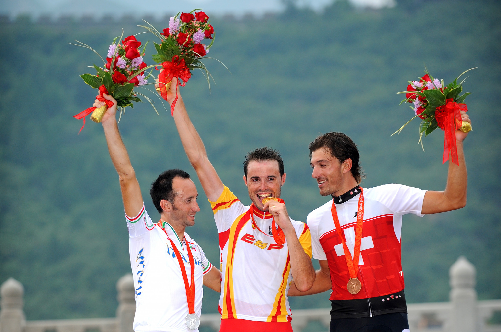 Italy's Davide Rebellin, left, celebrates winning an Olympic silver medal in the men's road race at Beijing 2008, but was later stripped of it after testing positive for banned drugs ©Getty Images