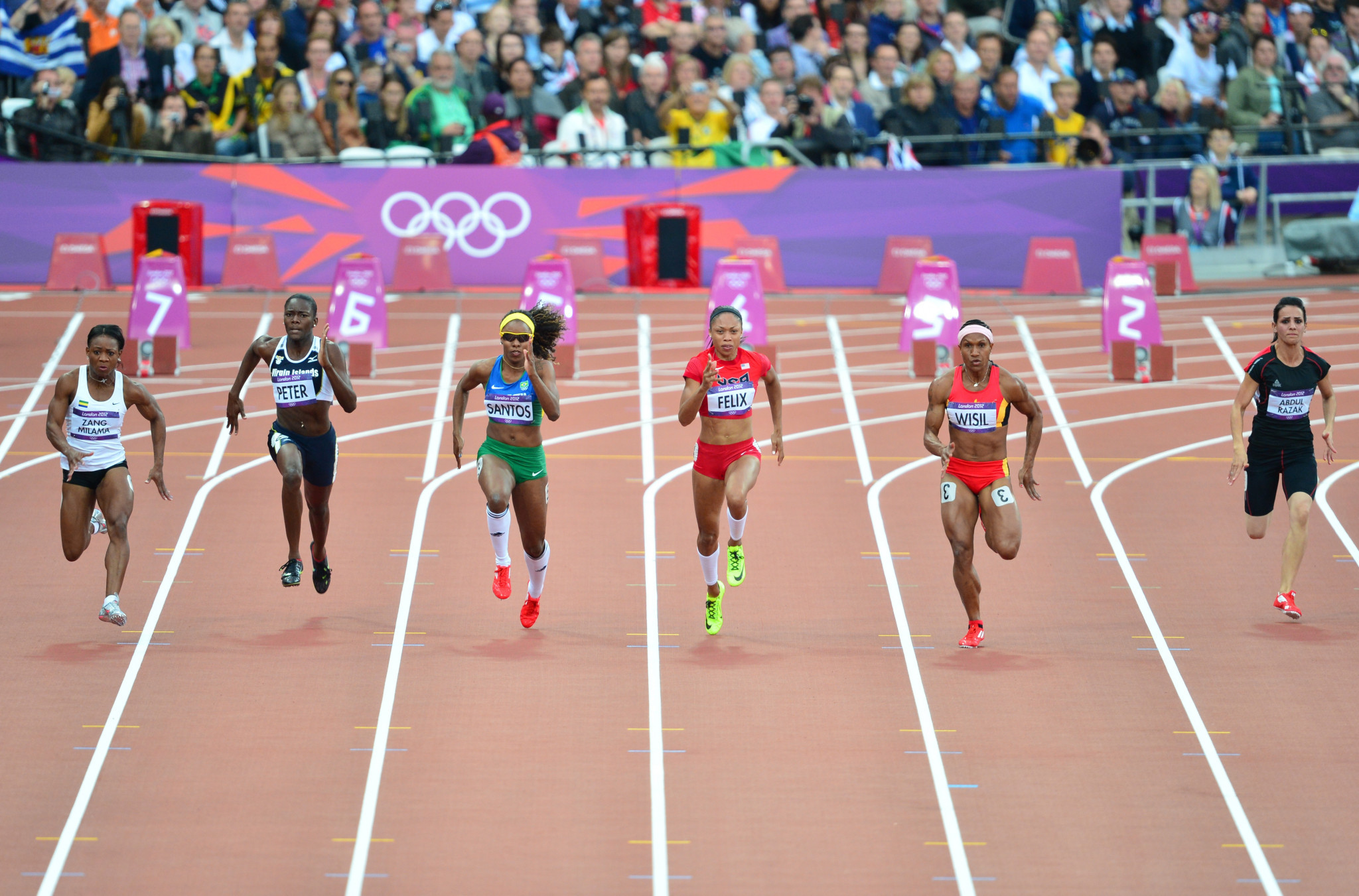 Dana Abdul Razak Hussain, far right, competed in the 100m at London 2012 in a heat won by the United States' Allyson Felix ©Getty Images