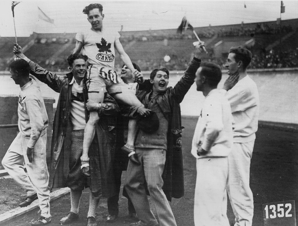 Percy Williams is held aloft by his Canadian team-mates after his 100 and 200m victories at the 1928 Olympics in Antwerp ©Getty Images
