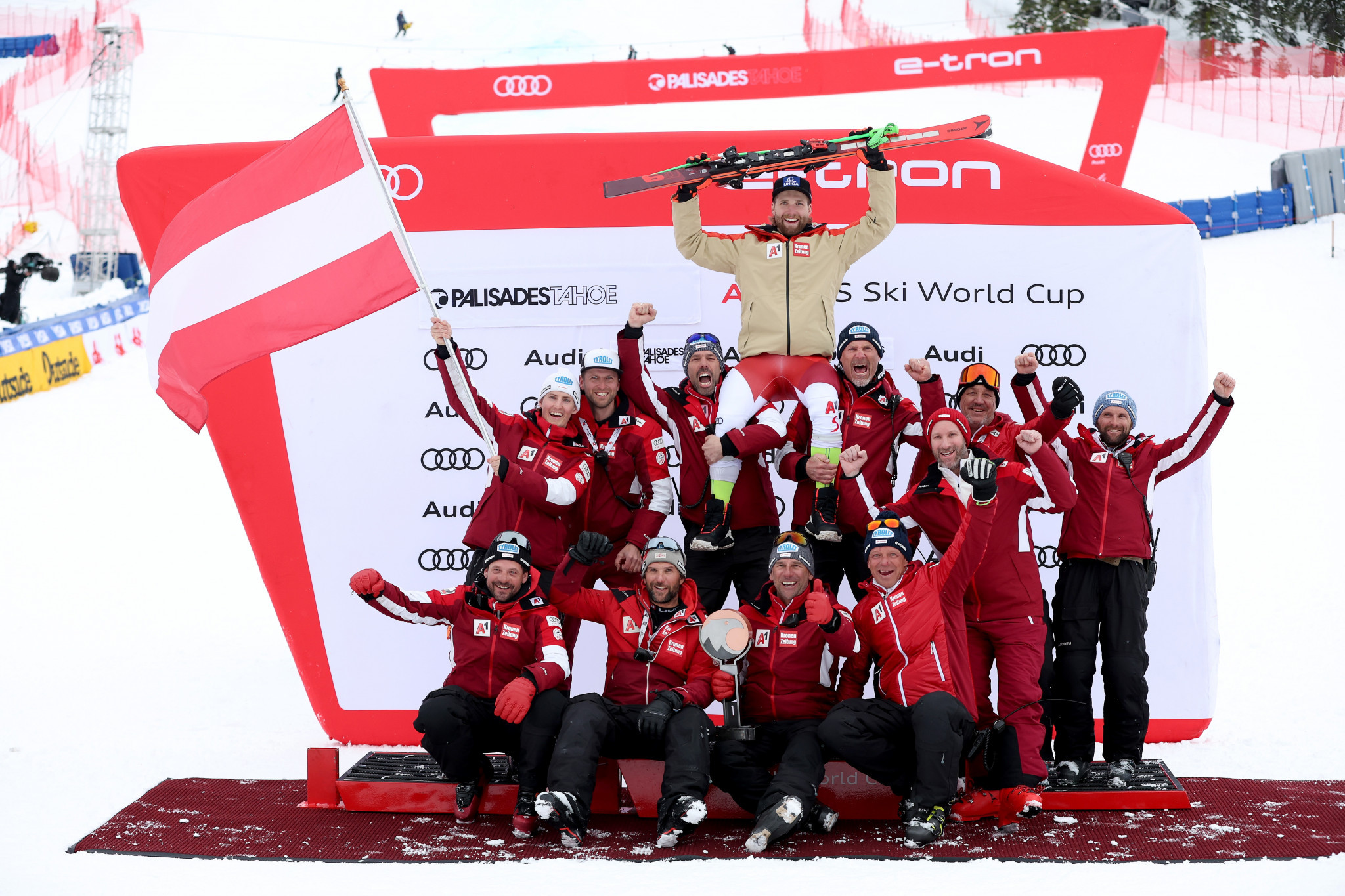 Austria's Marco Schwarz celebrates with his team after securing giant slalom gold in Palisades Tahoe ©Getty Images