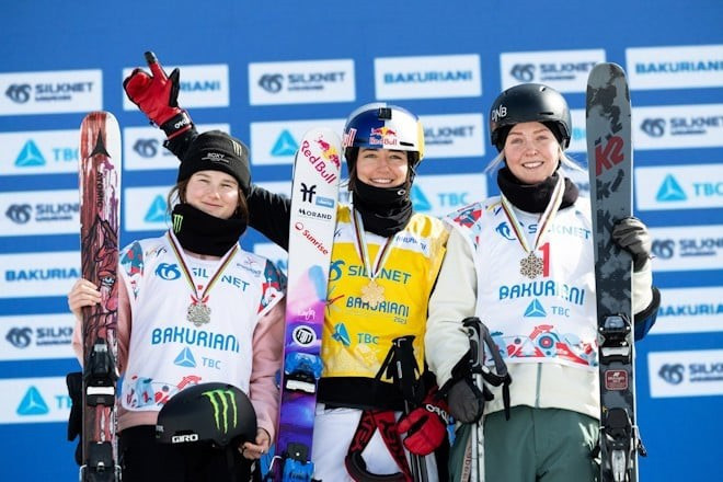 Mathilde Gremaud, centre, became the first competitor in freeski slopestyle history to hold the world and Olympic titles at the same time ©FIS