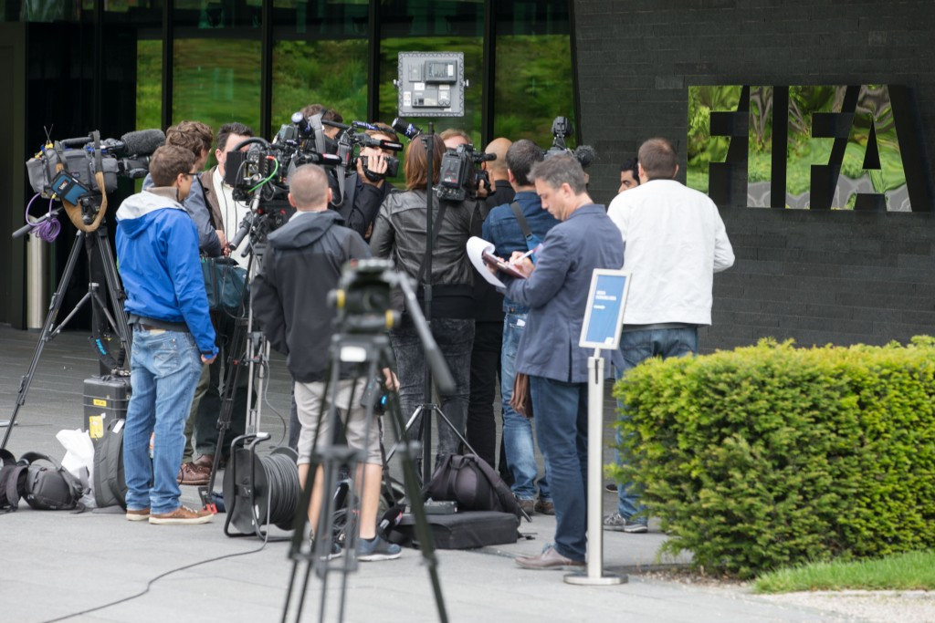 Journalists, photographers and TV crews queue to enter the FIFA headquarters