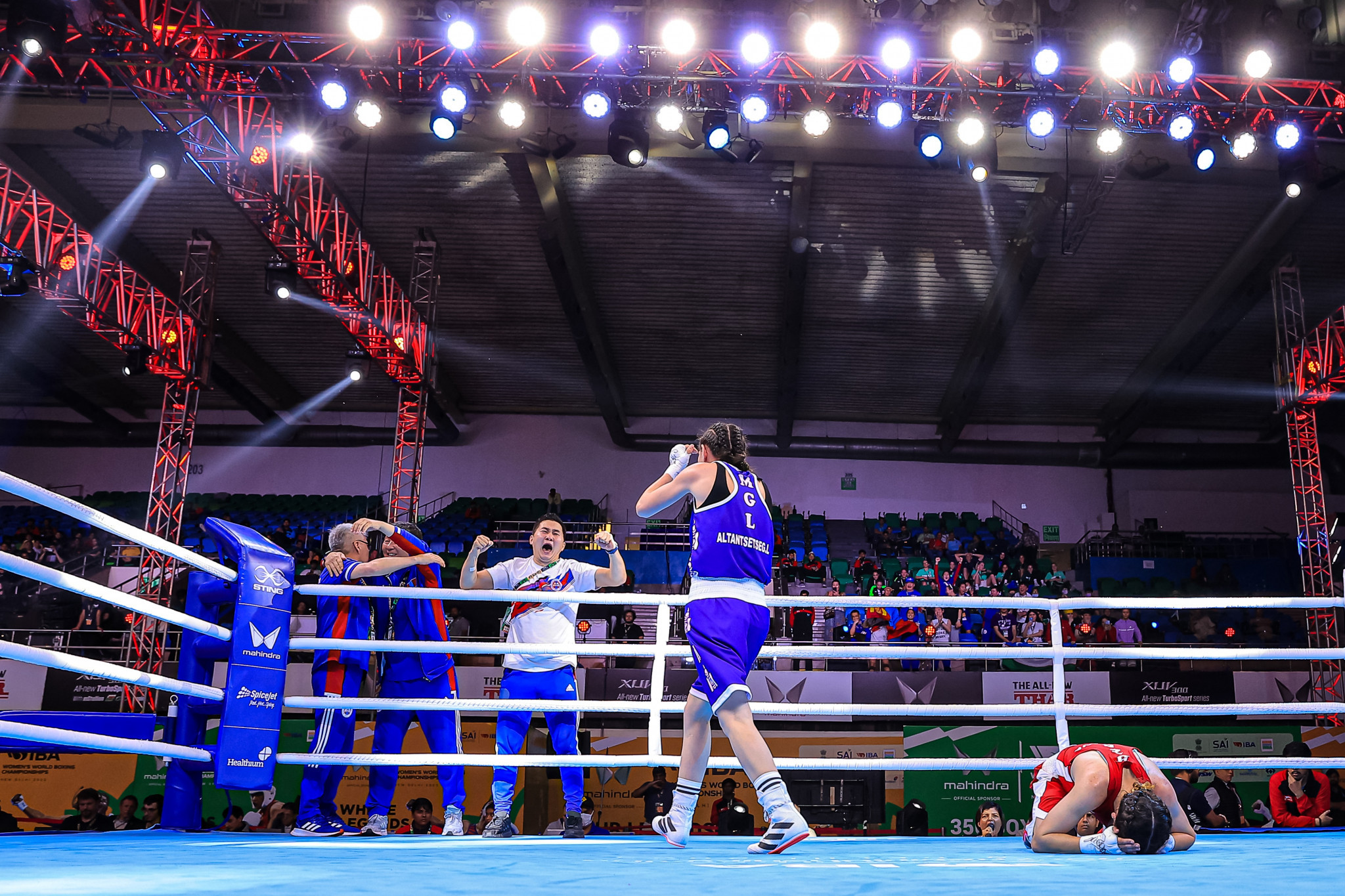 Altantsetseg Lutsaikhan of Mongolia looks to join in with the celebrations while Farzona Fozilova sinks to the ground following her quarter-final minimumweight defeat ©IBA
