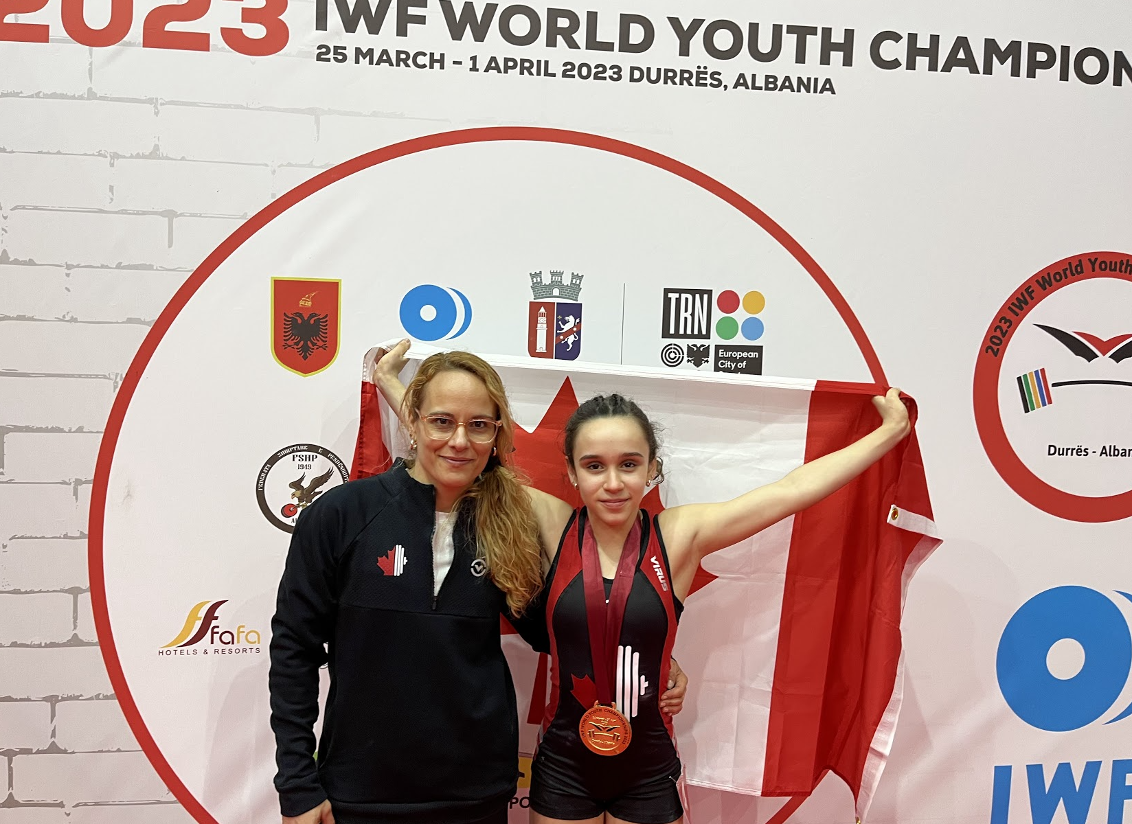 Canada's Ivy Buzinhani Brustello, right, won the 40 kilograms gold medal on the opening day of the IWF World Youth Championships in Albania at the age of only 12 ©IWF 