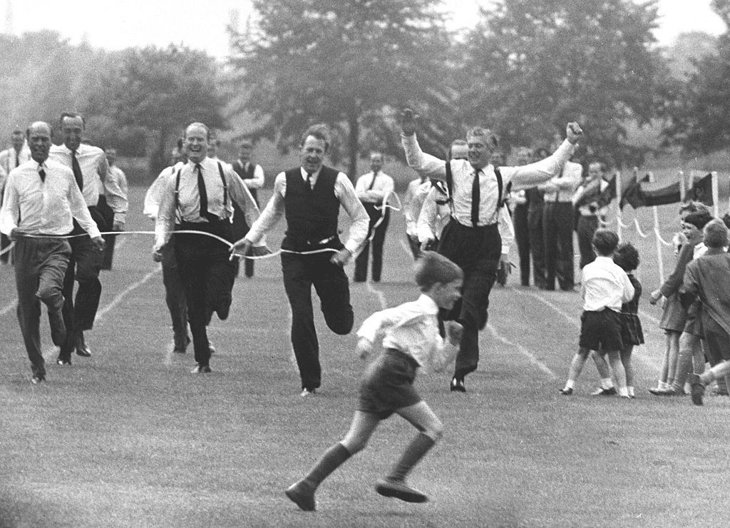 Competing at a school sports day parents' race in 1965 - 11 years after becoming the first man to break the Four Minute Mile, Sir Roger Bannister, wearing the waistcoat, finishes a smiling second ©Getty Images