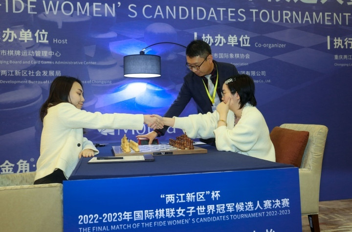 Tingjie, left and Zhongyi shake hands following game two of the FIDE Women's Candidates Tournament final ©FIDE/Liu Yi