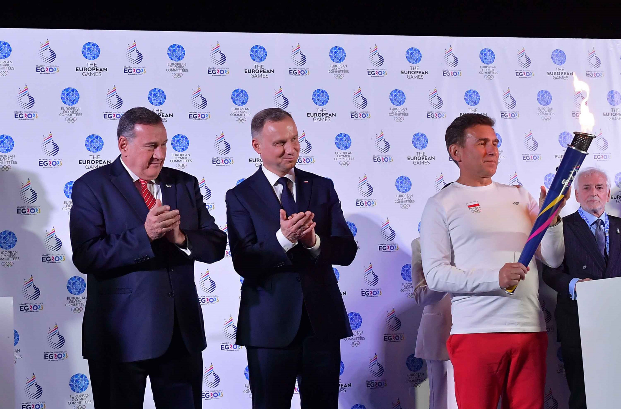Four-time Olympic race walk champion Robert Korzeniowski collects the Flame of Peace ©EOC
