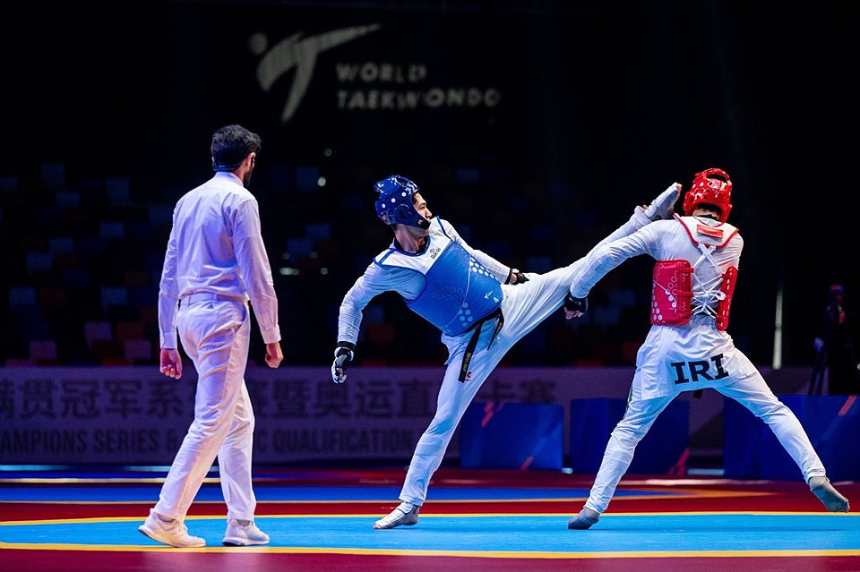 Jasurbek Jaysunov, in blue, triumphed in the men's under-80kg category in Wuxi ©Getty Images  