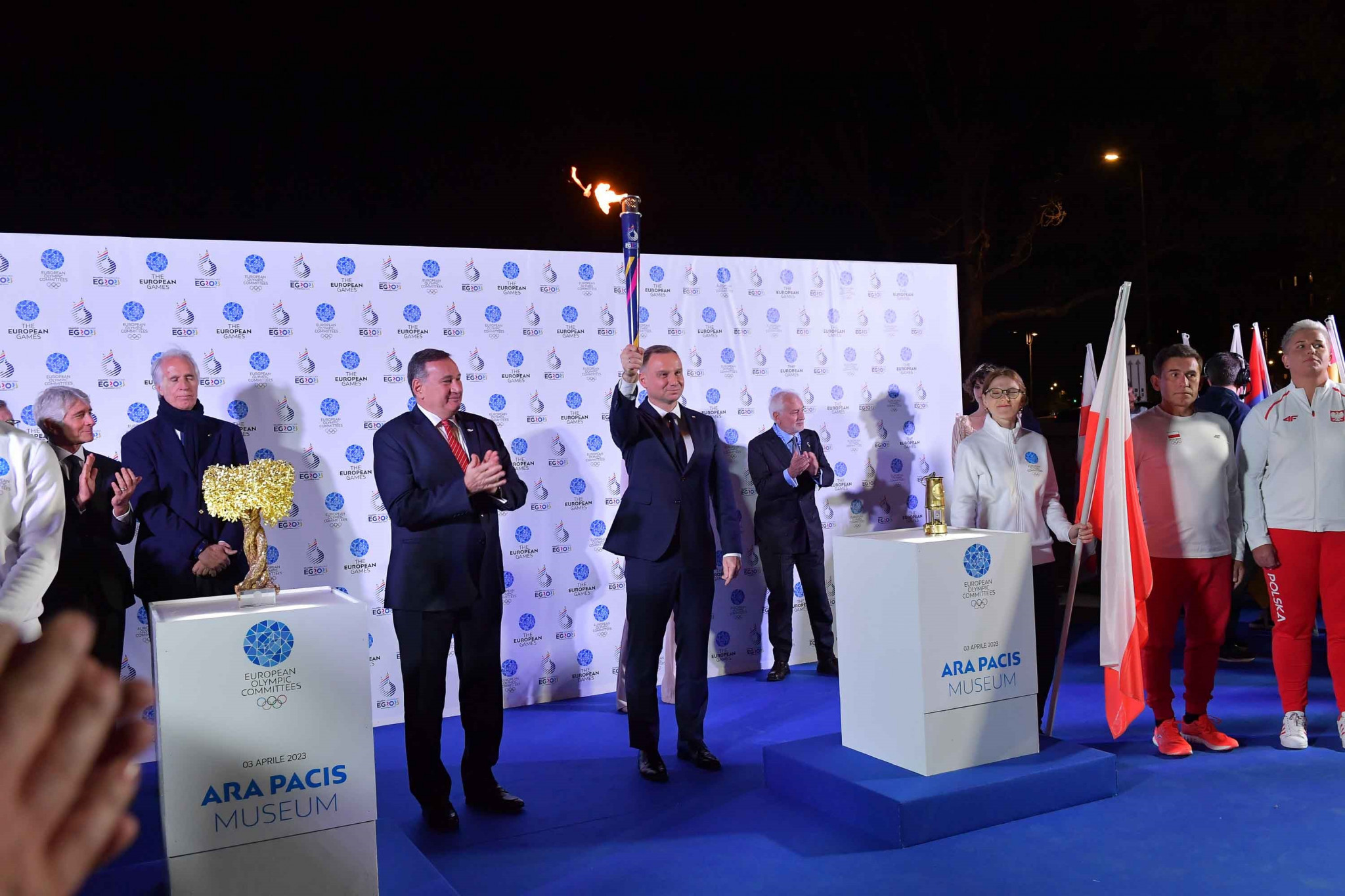 Poland’s President Andrzej Duda holds aloft the Flame of Peace at the handover ceremony in Rome ©EOC