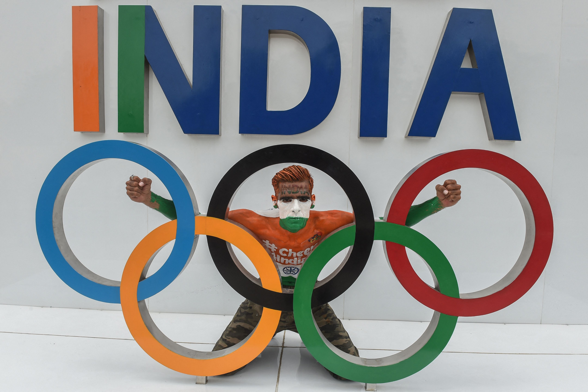 An Indian supporter back his country behind the Olympic Rings ©Getty Images