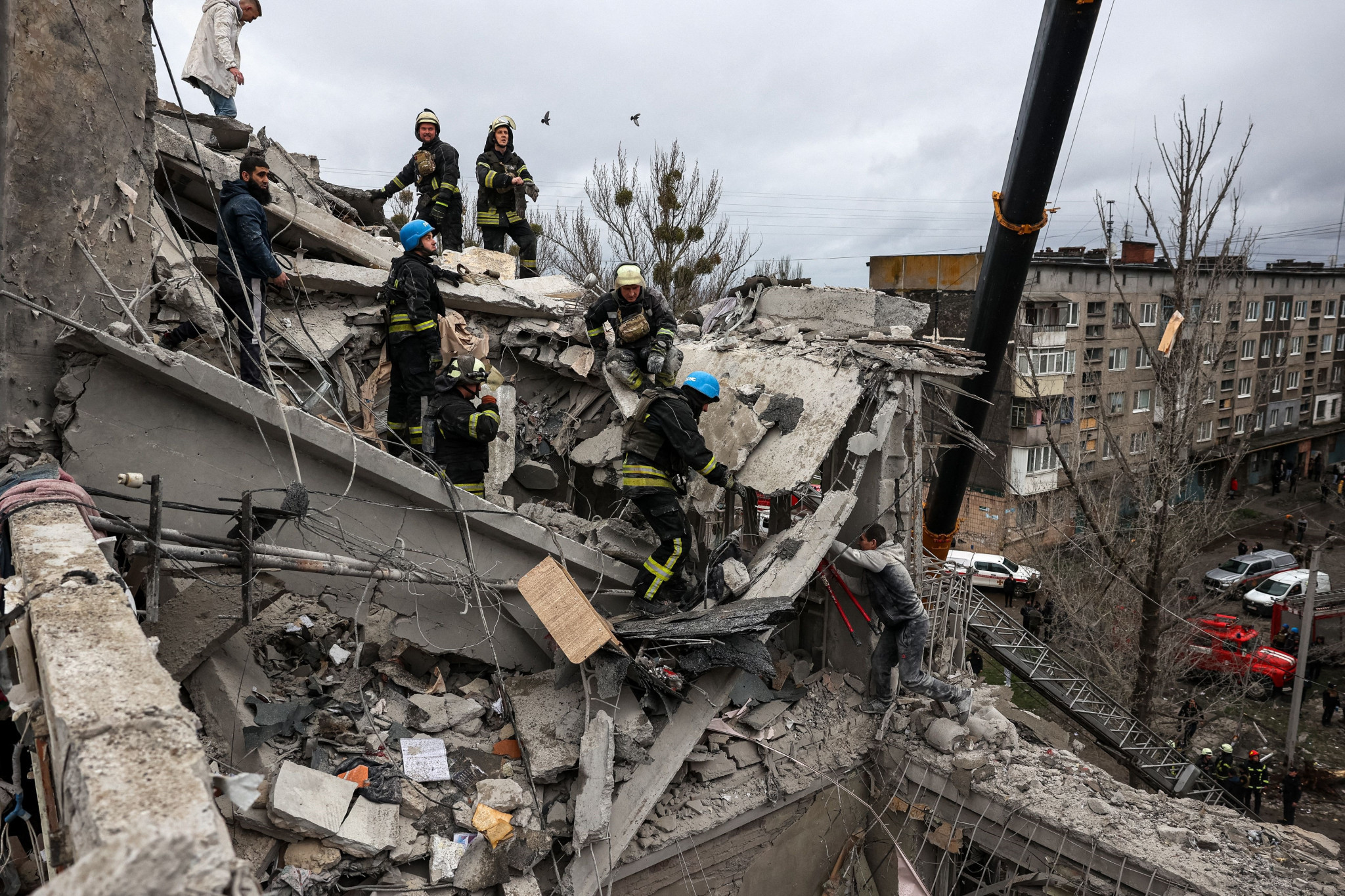 Rescuers search for survivors on the top of a partially destroyed residential building after a sheling in Sloviansk that killed eight people including a toddler ©Getty Images