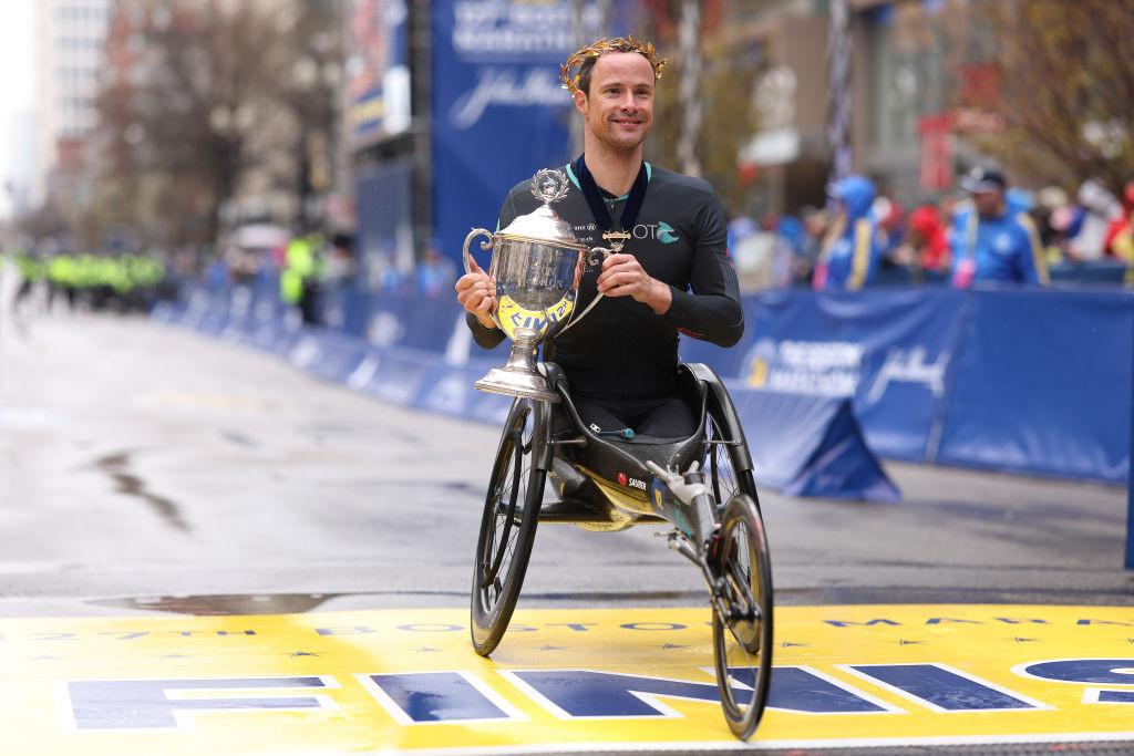 Switzerland's Marcel Hug, pictured after winning a record sixth Boston Marathon men's wheelchair title on Monday, will seek a third consecutive London title tomorrow ©Getty Images