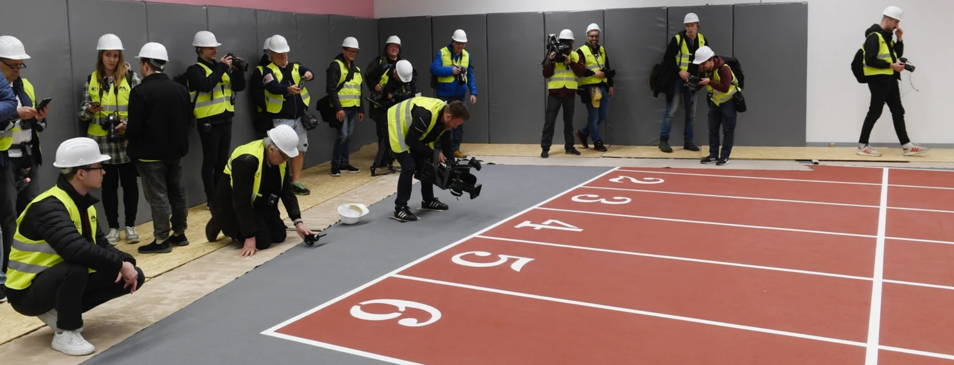 The media get a first look at the newly-finished six-lane indoor track which has been completed at the National Athletics Centre, which will stage this summer's World Athletics Championships ©Budapest 2023